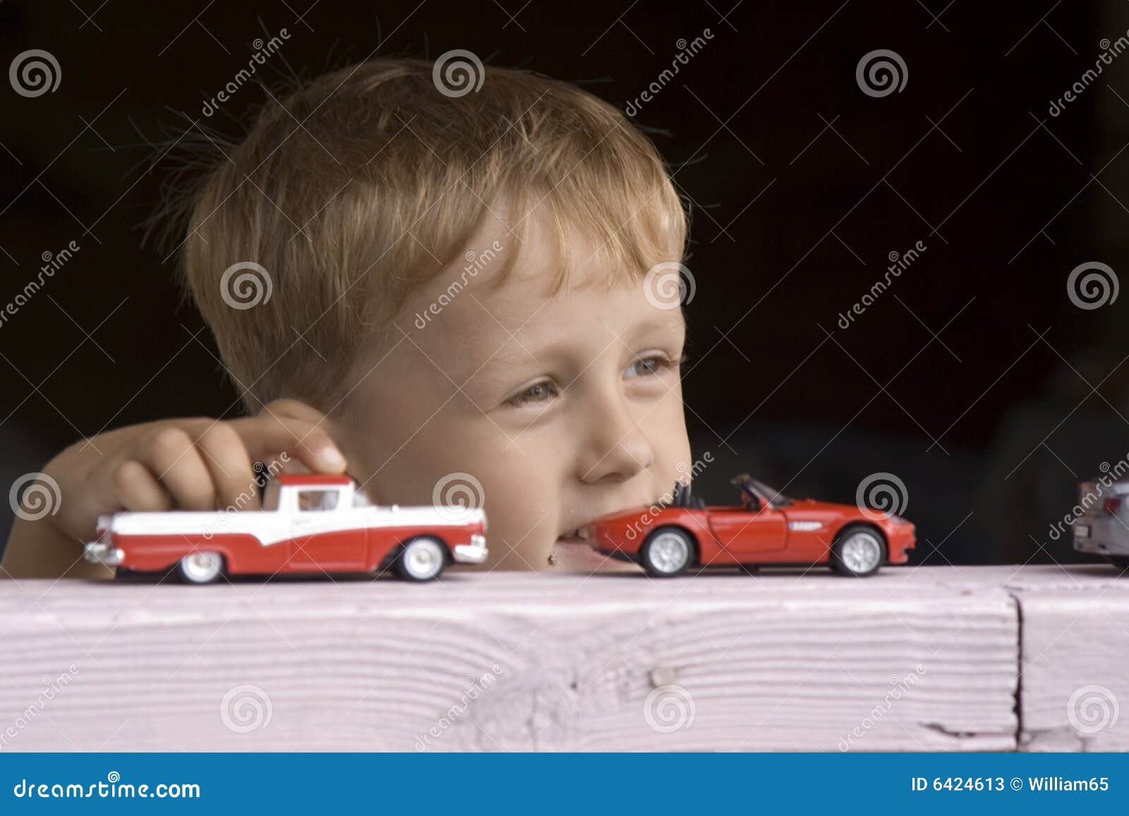 little boy plays a toy car