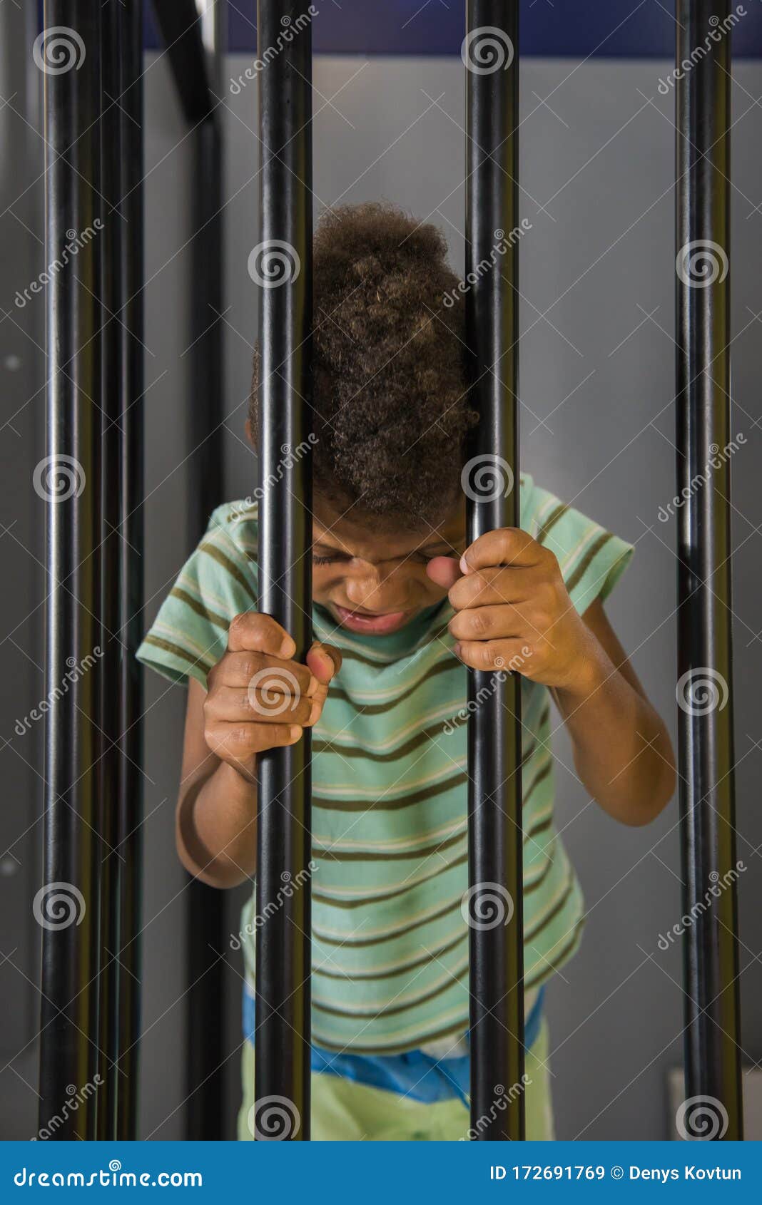 Kid Prisoner Try To Escape from Jail. Stock Image - Image of