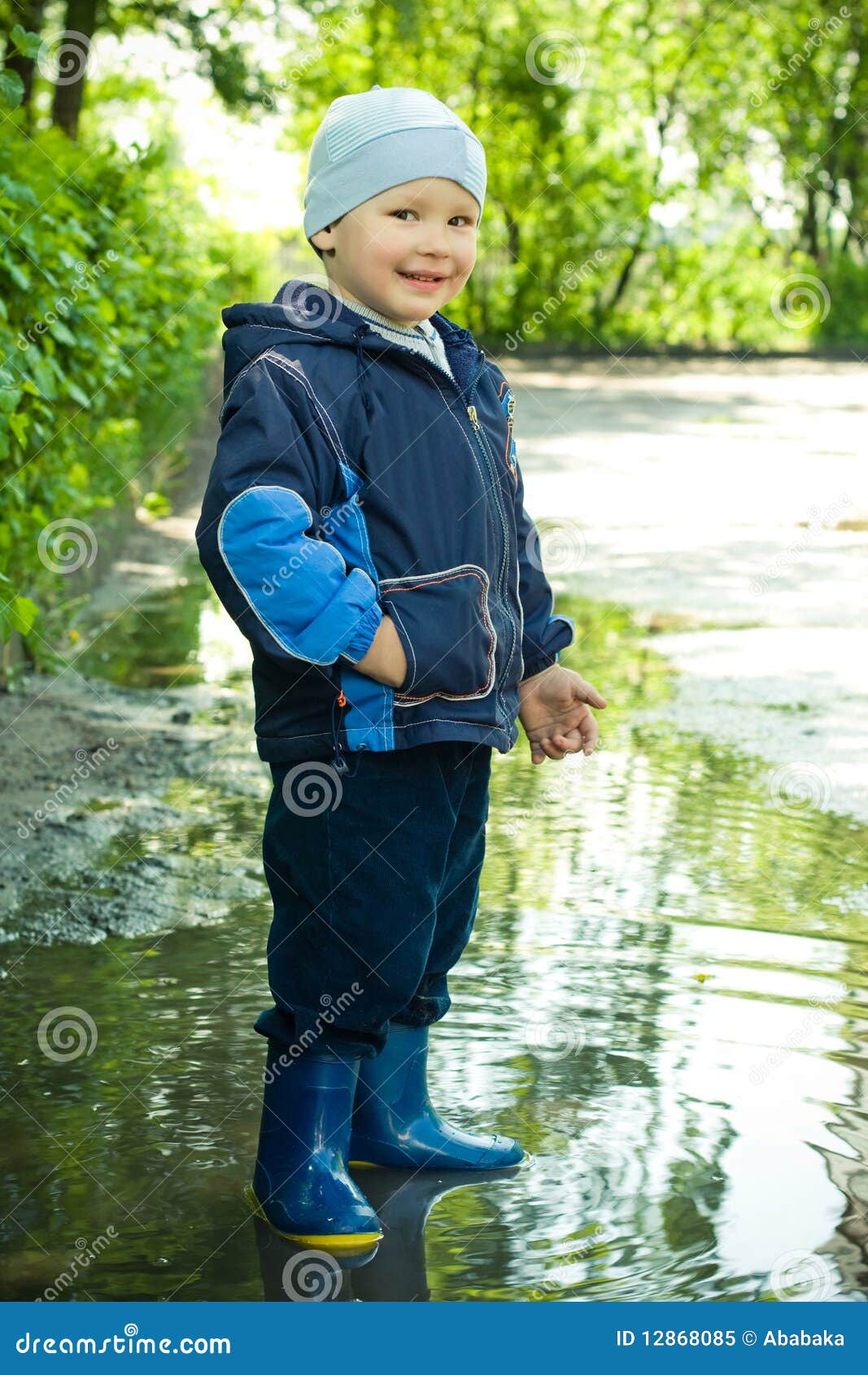 Little boy in the puddle stock image. Image of jacket 12868085