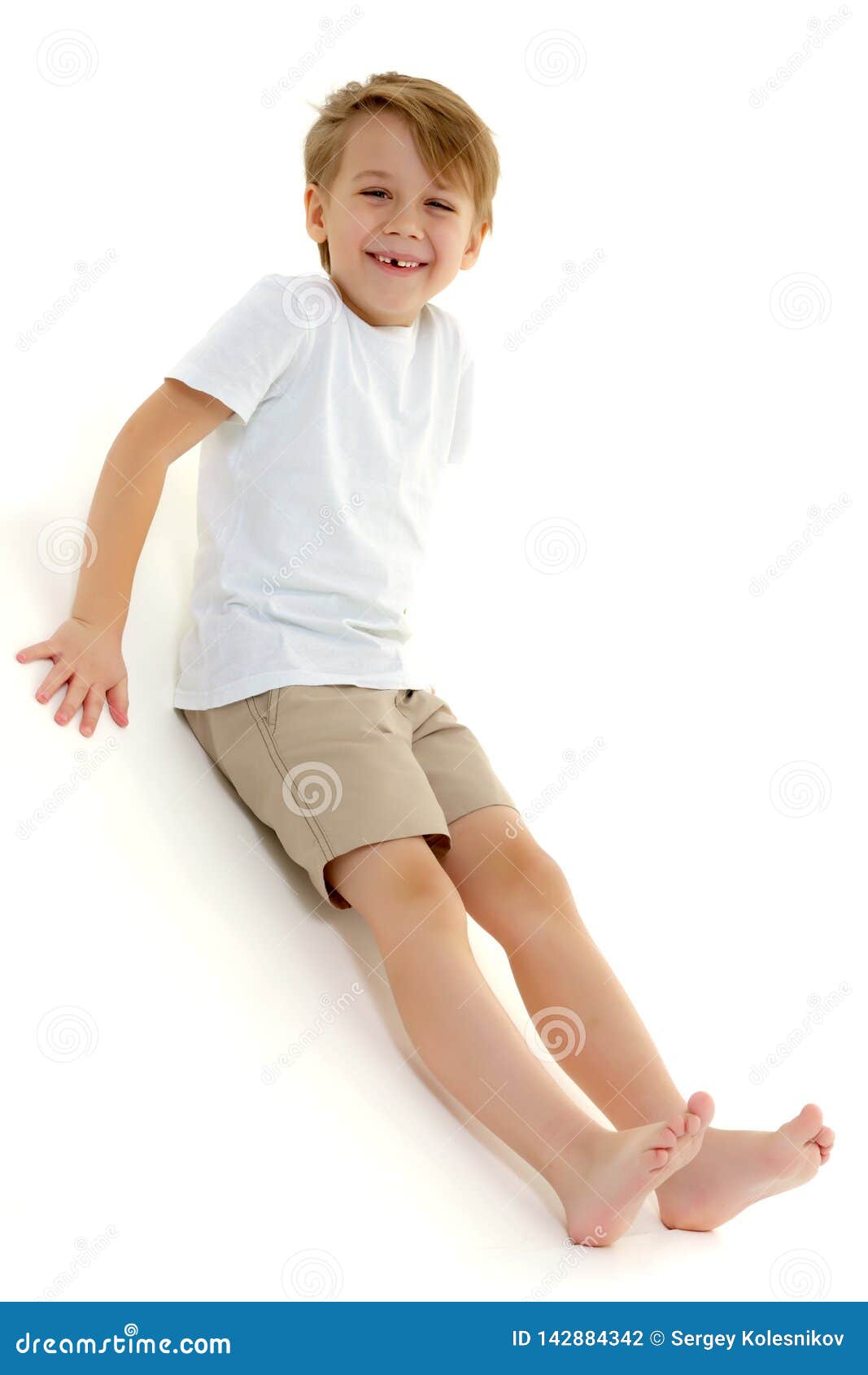 A Little Boy in a Pure White T-shirt Laughs. Emotions. Stock Photo ...