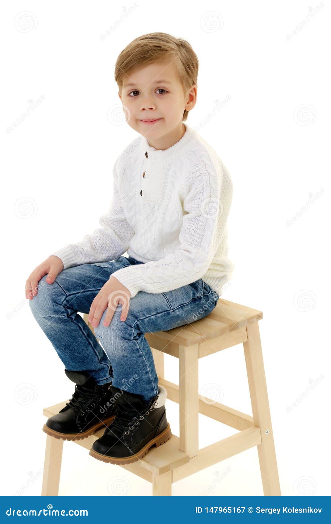 A Little Boy is Sitting on a Chair. Stock Image - Image of comfort
