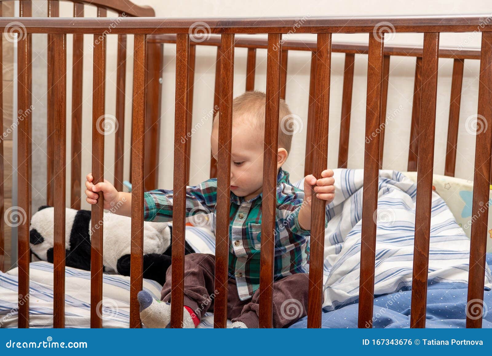 Little Boy is Sitting in a Cot in the Bedroom Stock Photo Image of