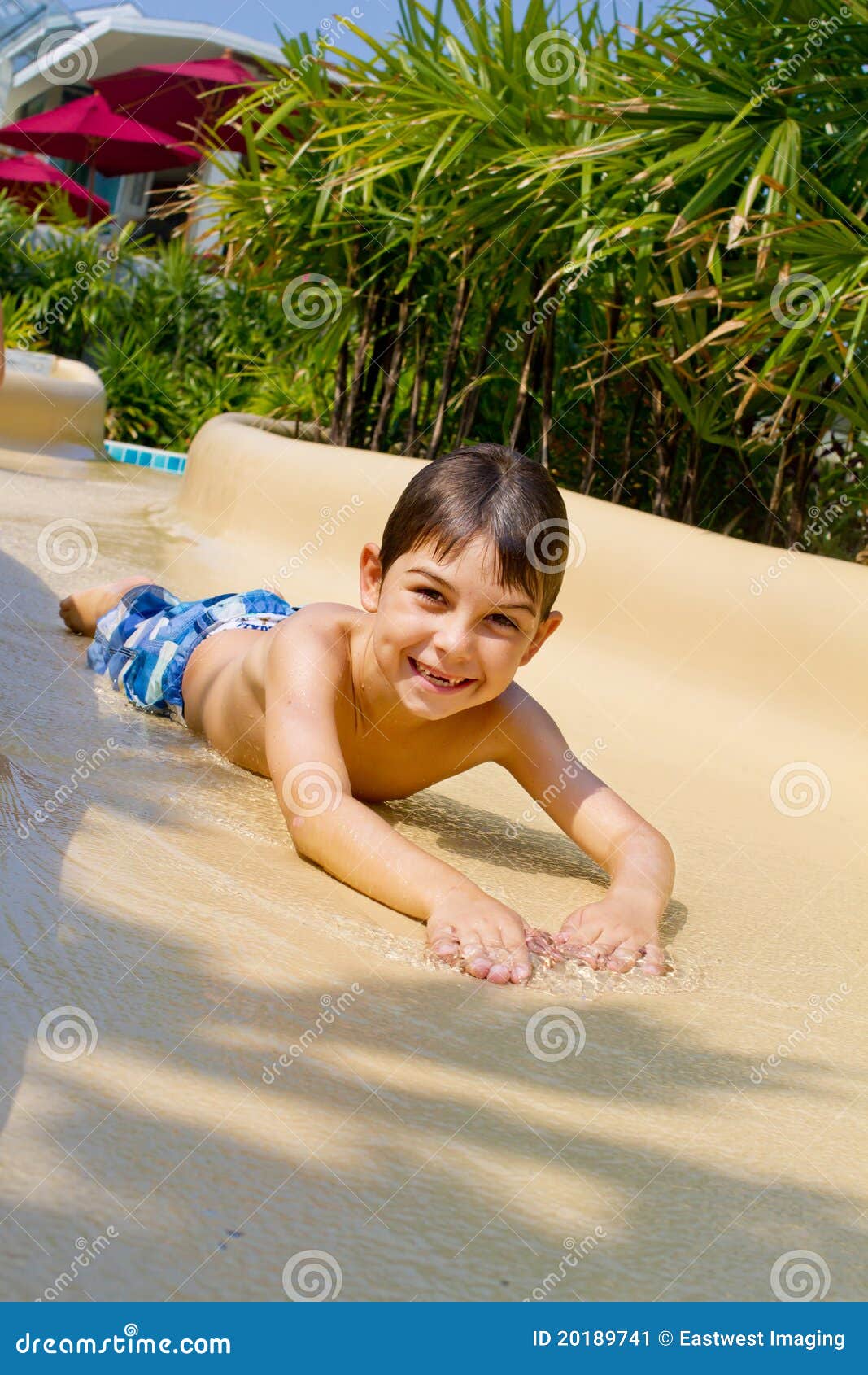 Little Boy Sliding Down Water Slide Stock Image - Image of portrait
