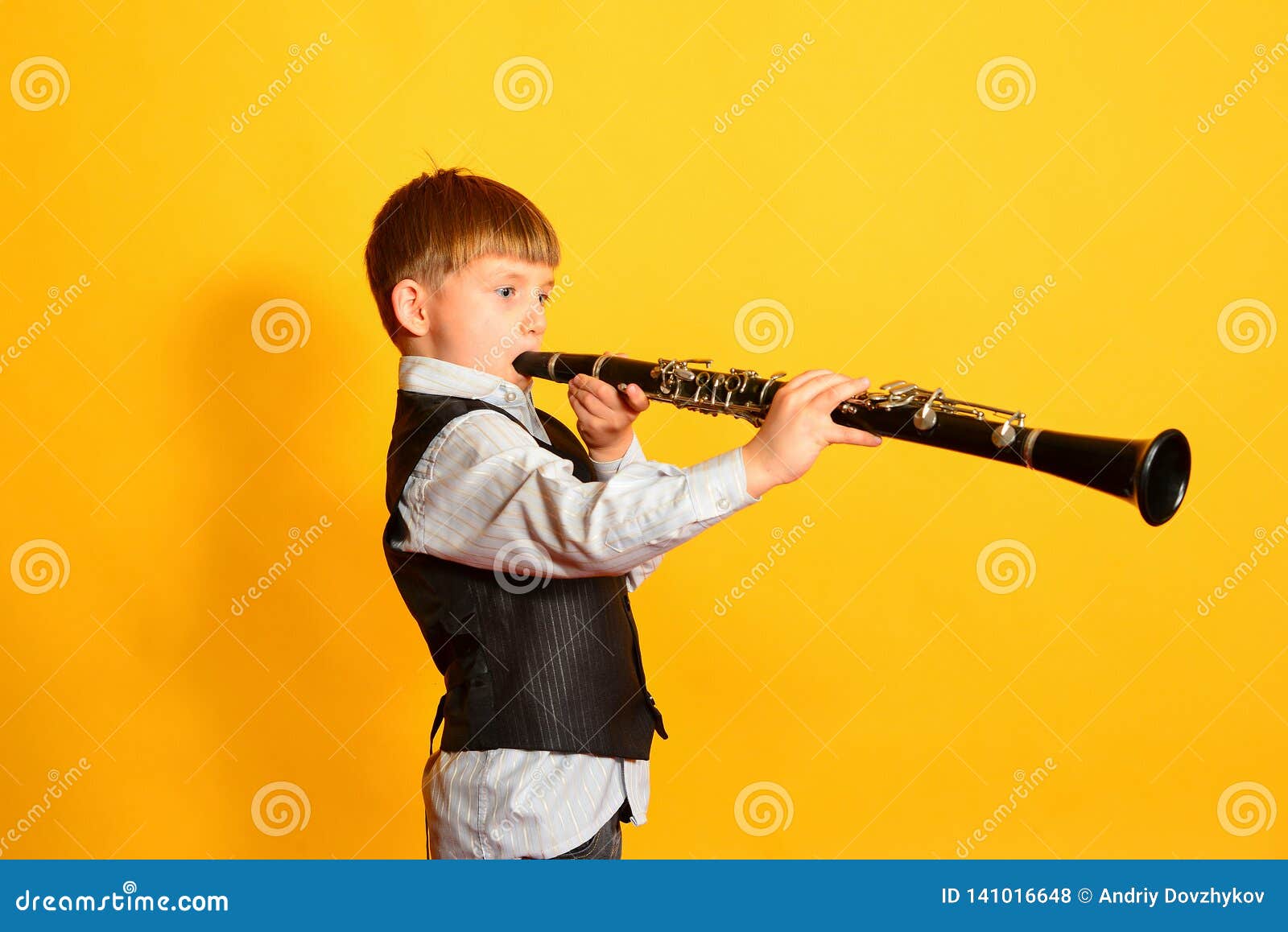 A Little Boy in a Suit Plays the Stock Photo Image of plays