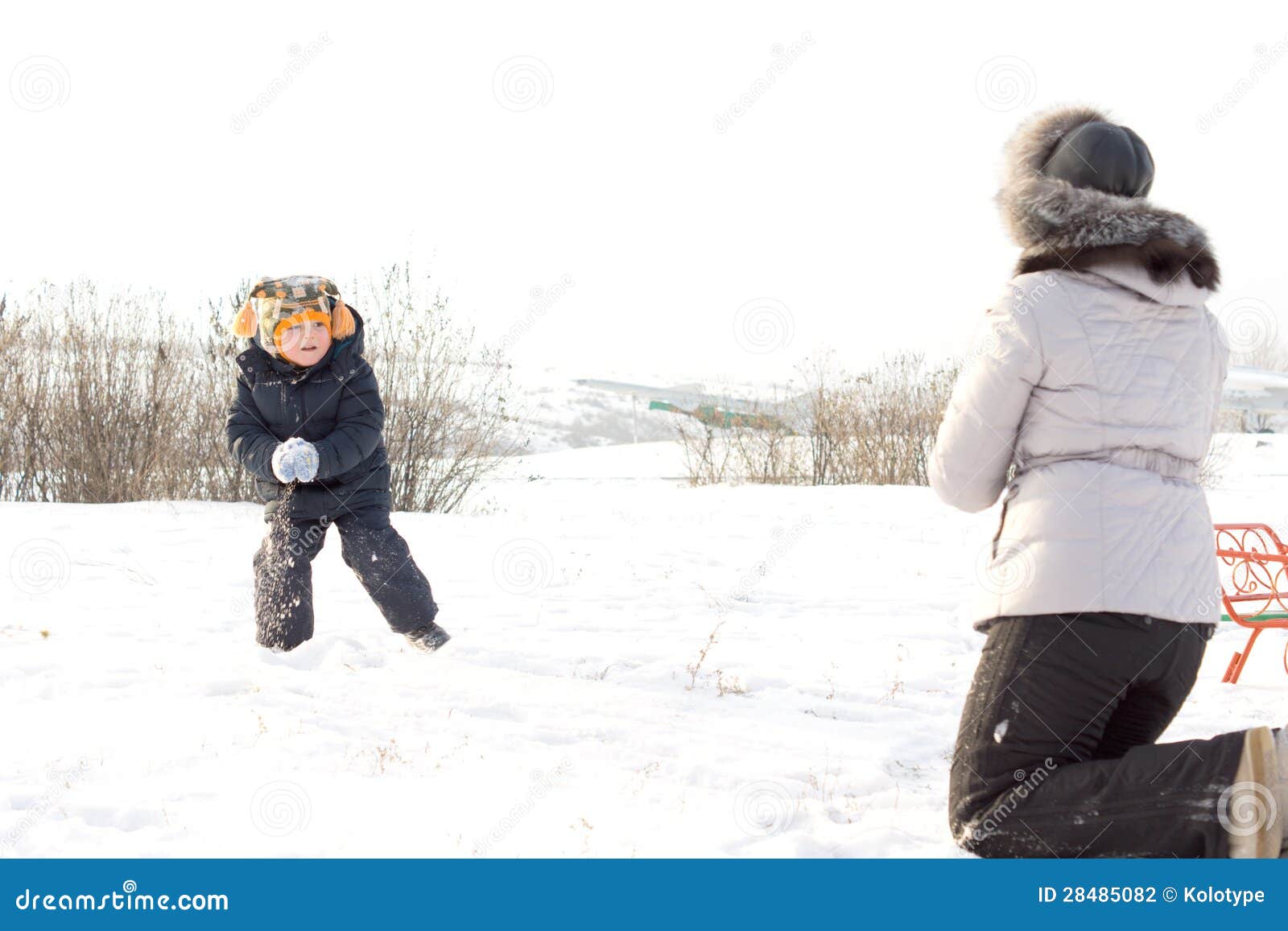 Little Boy Throwing Snowballs at His Mother Stock Photo - Image of ...