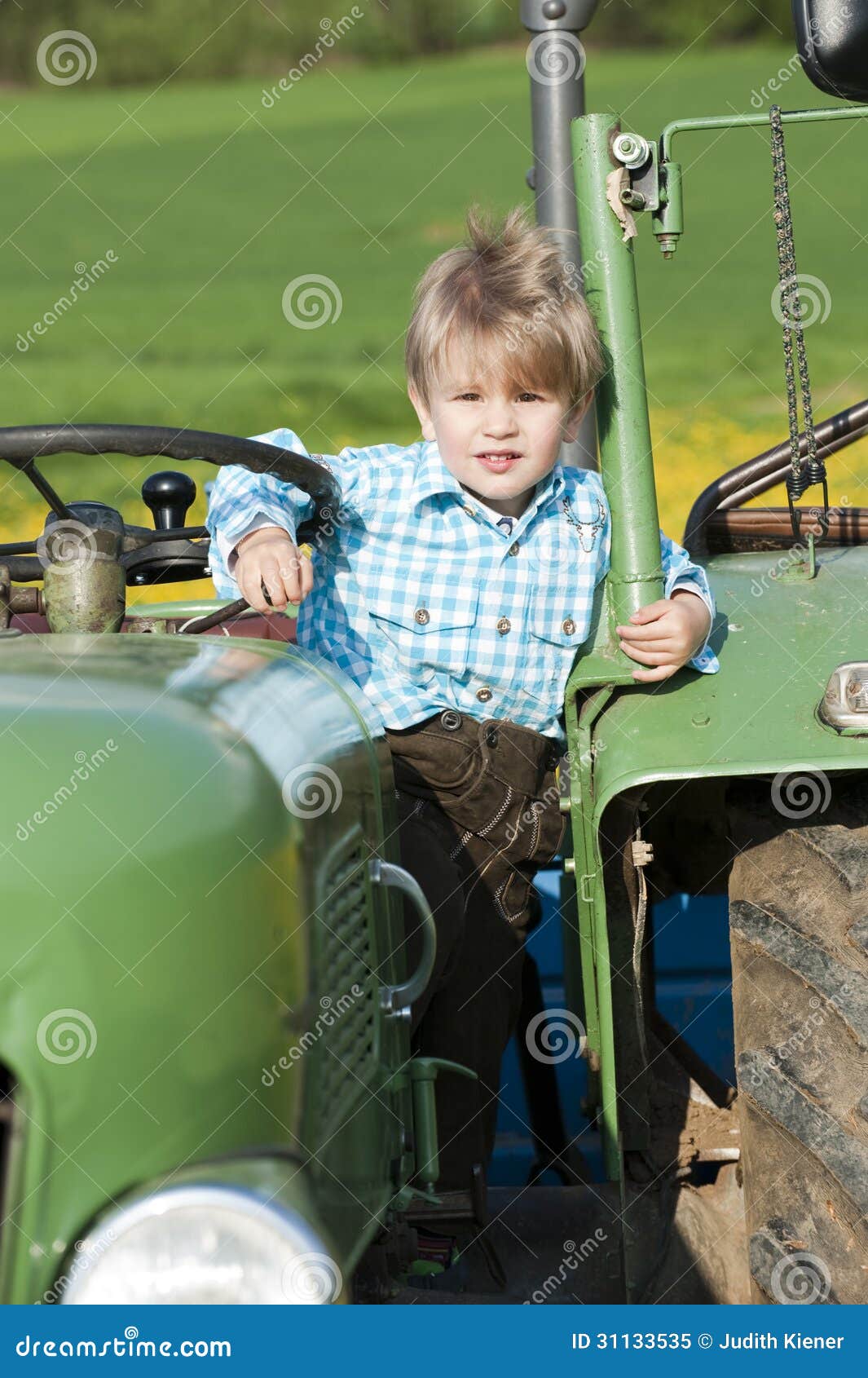 Little boy on a tractor stock image. Image of costume 31133535