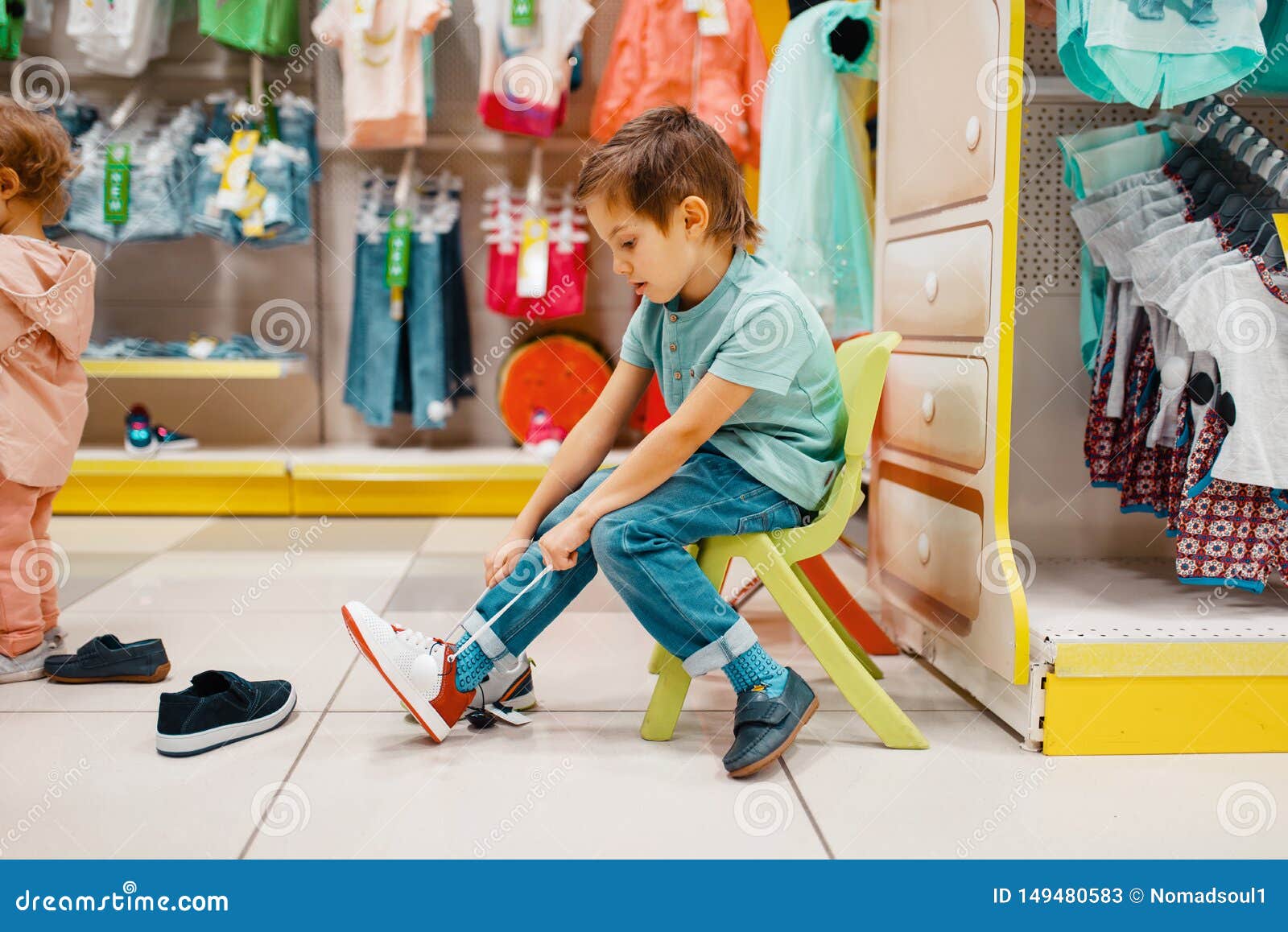 Child putting on his shoes stock image. Image of child 