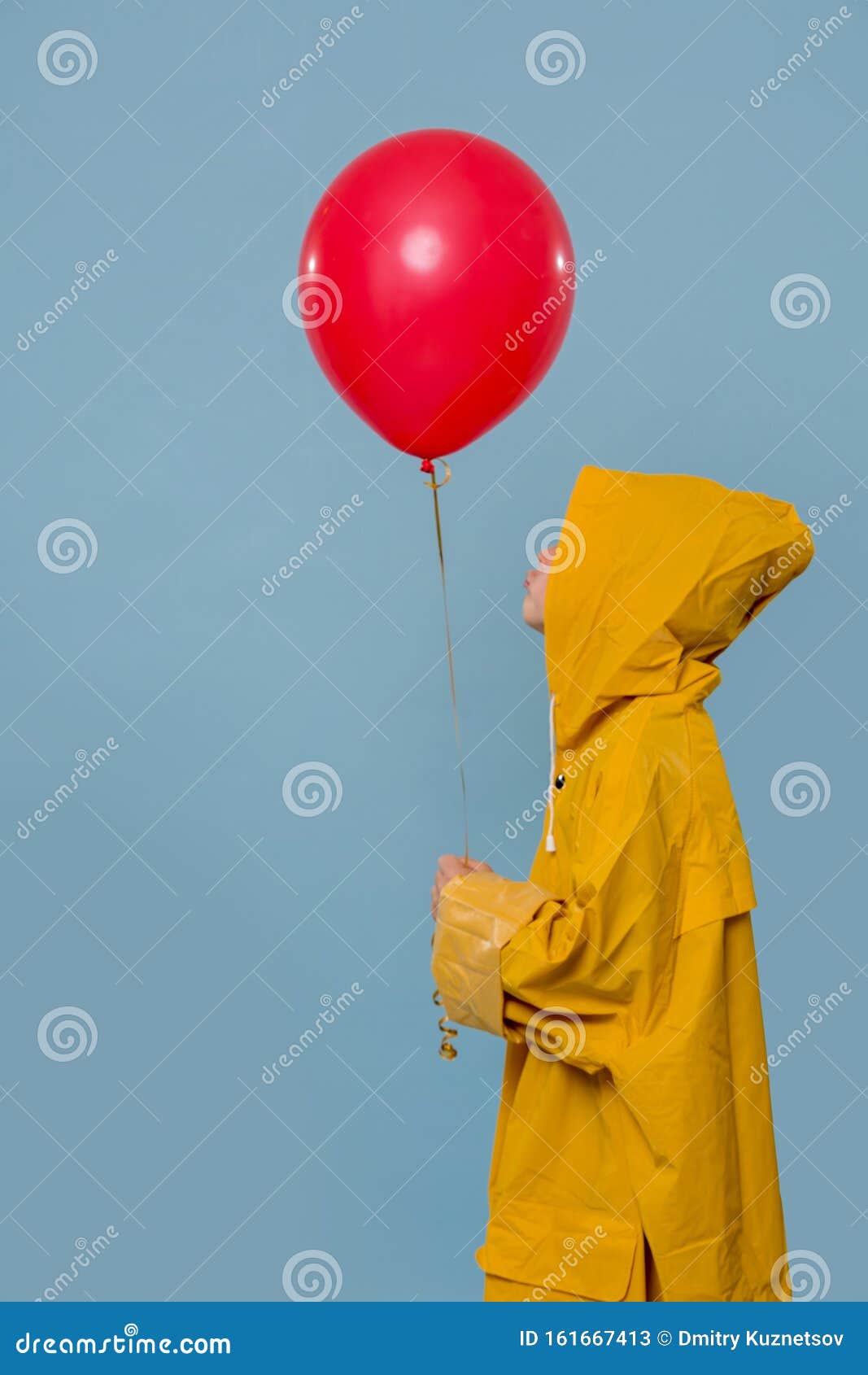 Little Boy in Yellow Raincoat with Red Balloon Over Blue Background ...