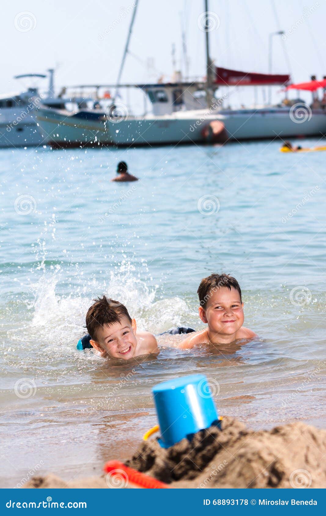 Little boys in blue sea stock photo. Image of happy, children 68893178