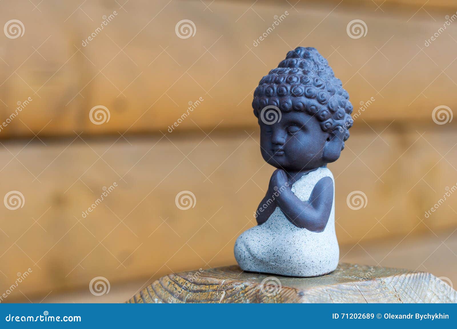 Little Buddha Pray or Meditate on Wooden Background with Empty