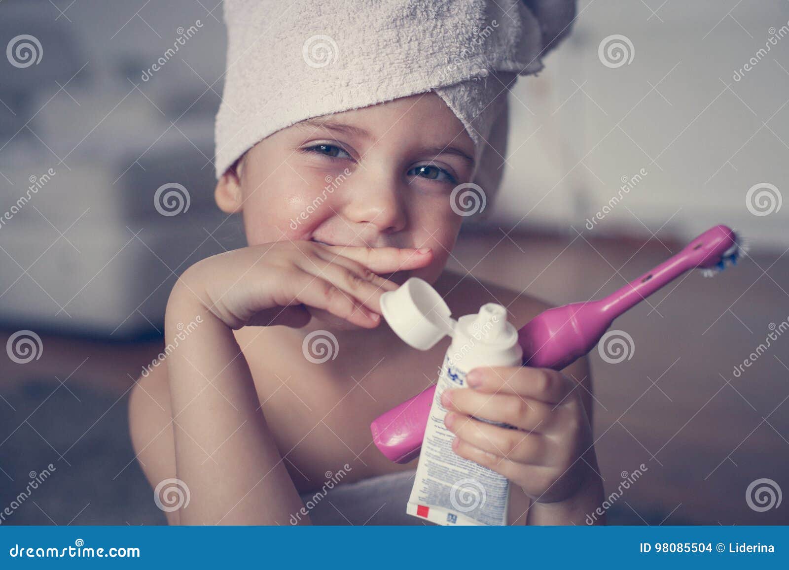 Little Caucasian Girl Brush Her Teeth In The Bathroom Stock Photo