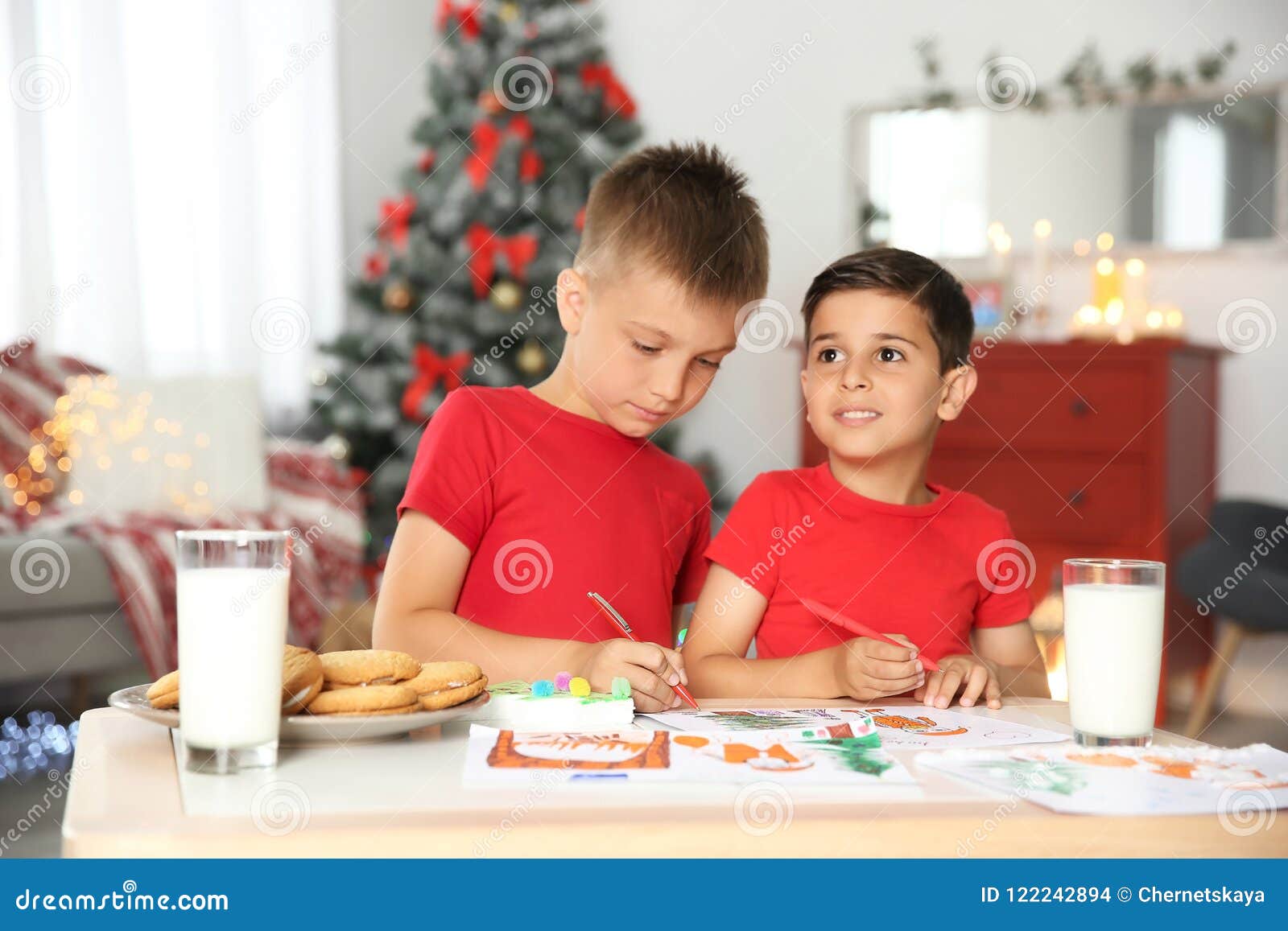 Little children drawing picture at home Christmas celebration