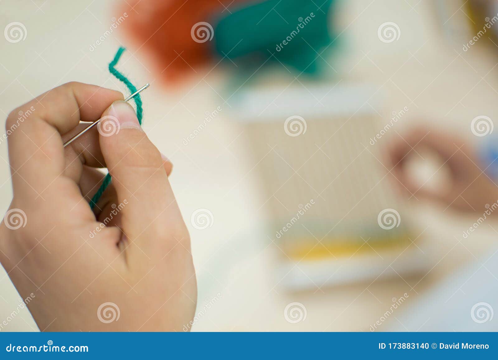 little children hands weaving loom in art theraphy class at school. education concept. telar weave looom