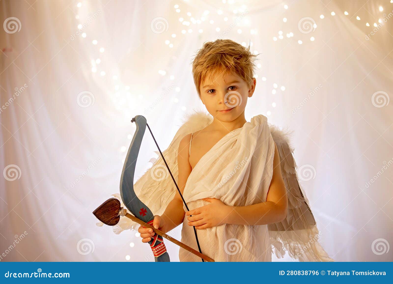 little cupid toddle boy, holding bow and arrow, beautiful blond cherub