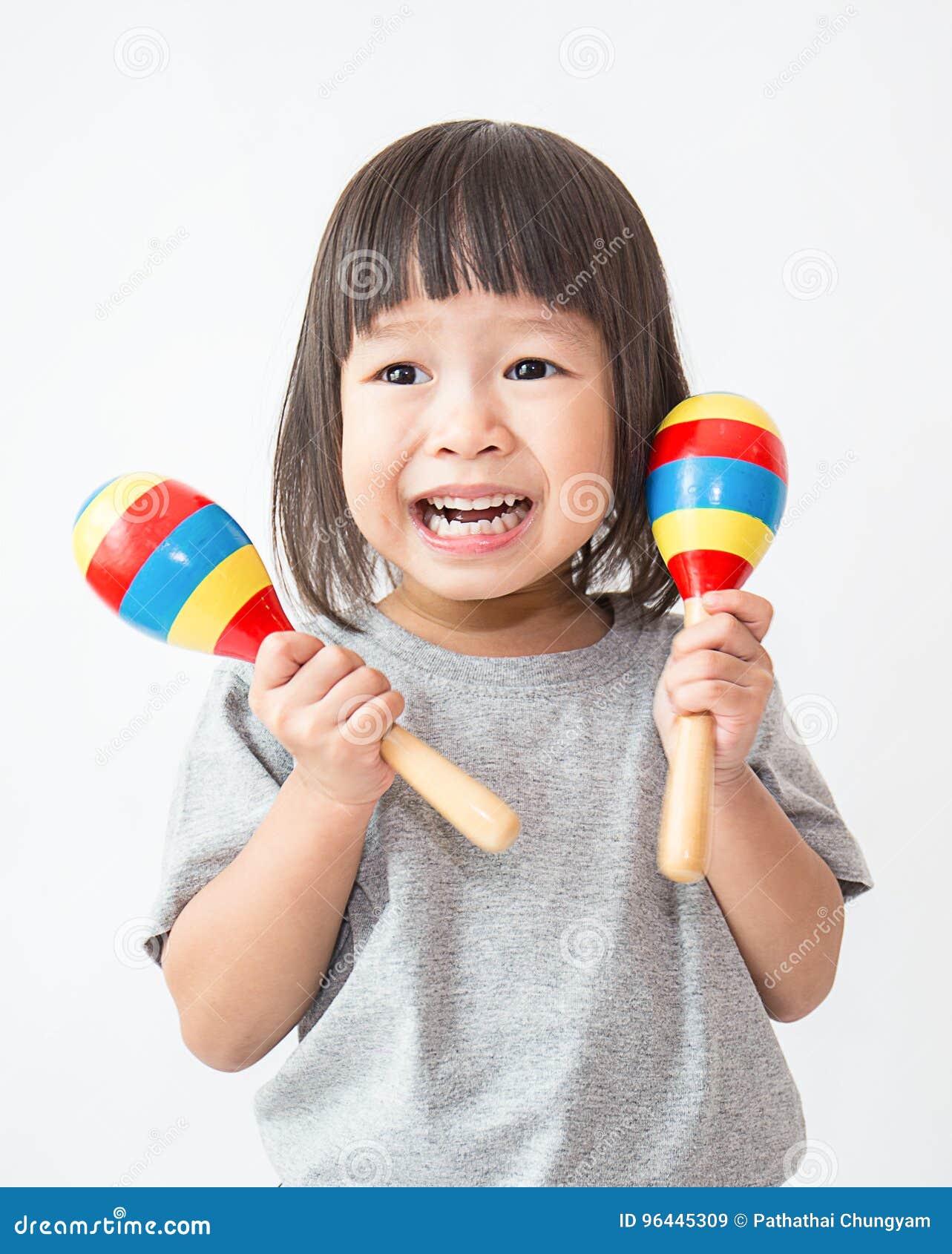 little cute asian girl playing the maracas