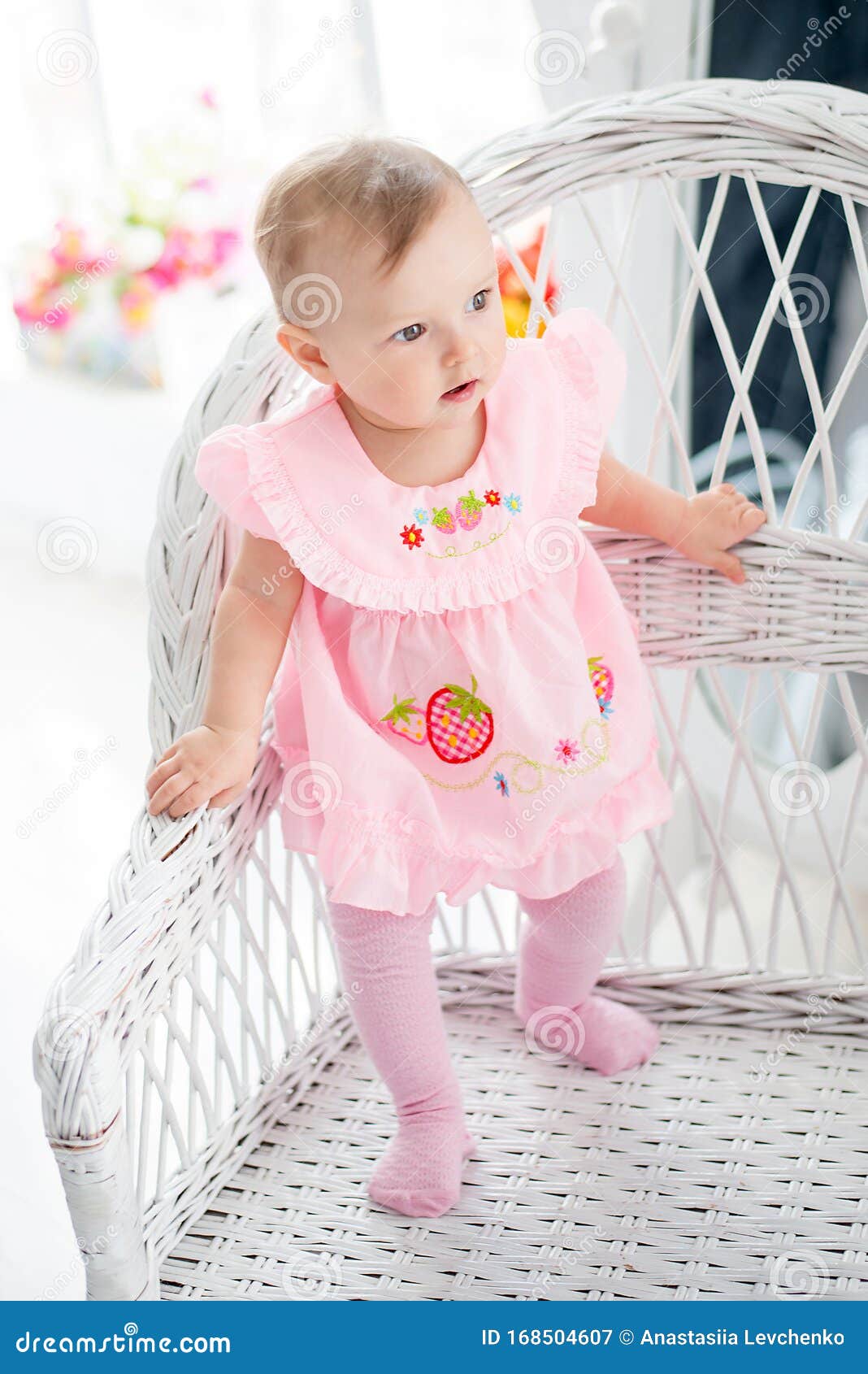Little Cute Baby-girl in Pink Dress Standing on a White Chair ...