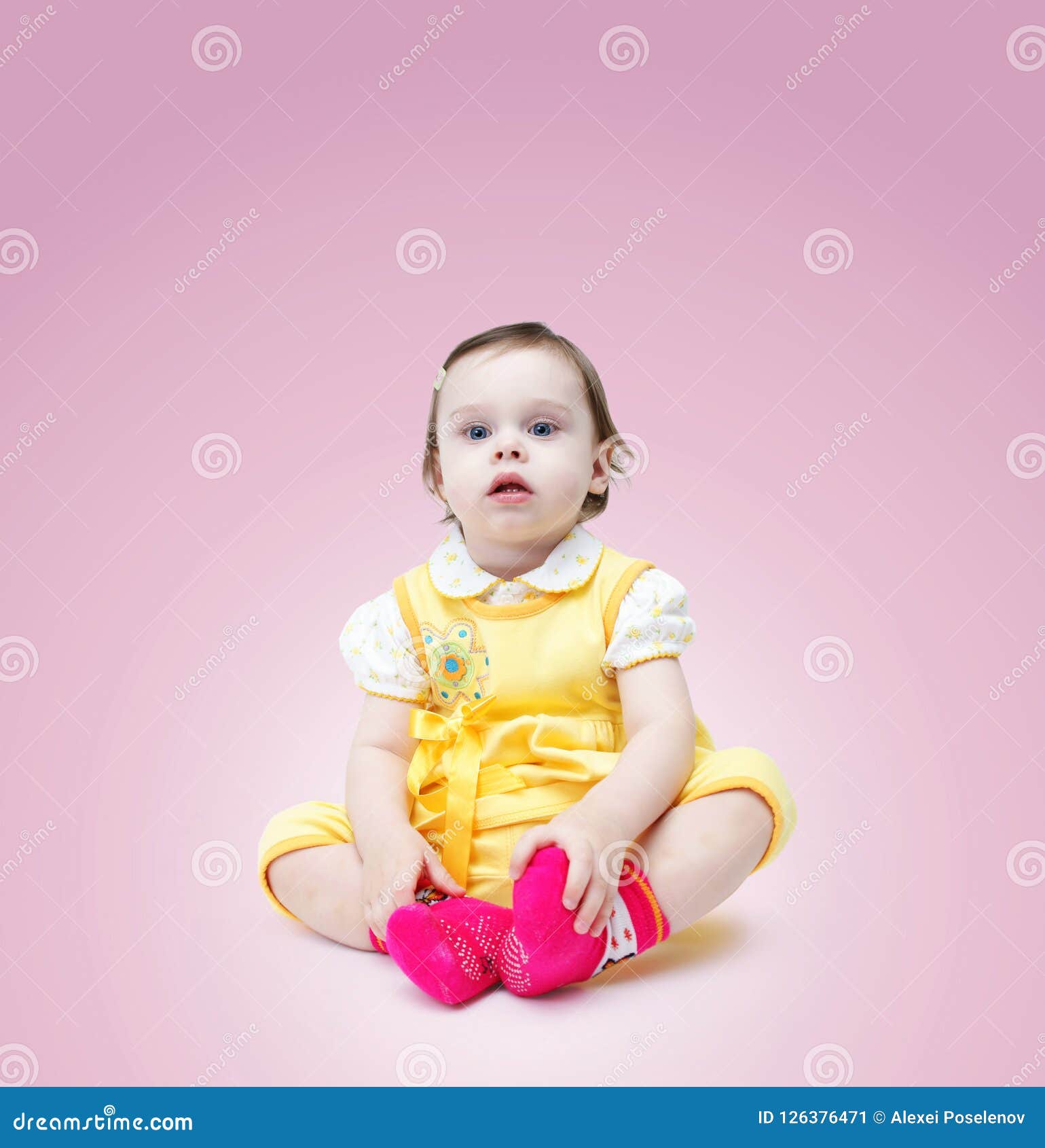 baby girl in yellow dress