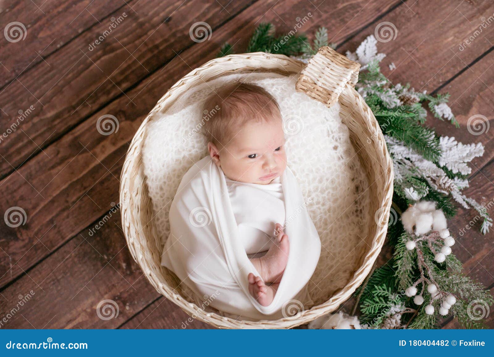 Little Cute Baby in a White Blanket in a Wicker Basket Decorated with ...