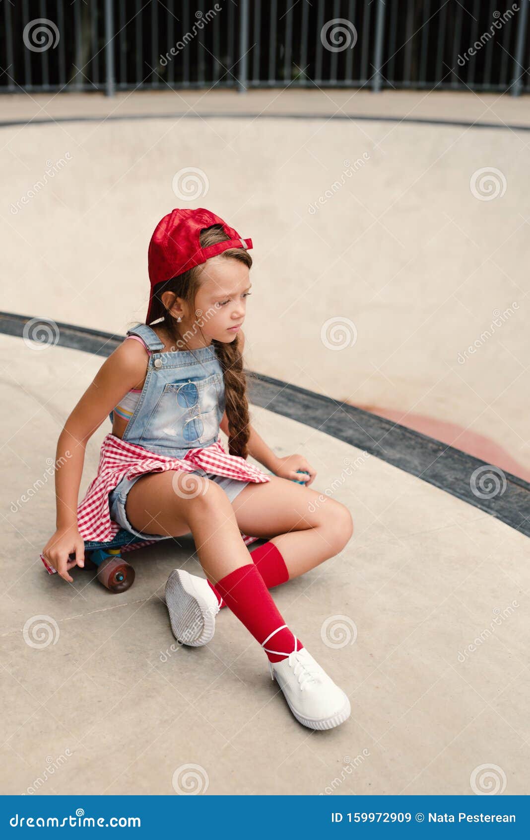 Little Cute Girl With Sunglasses And Cap Sitting On A Skateboard Photo Of Cute Preteen Girl