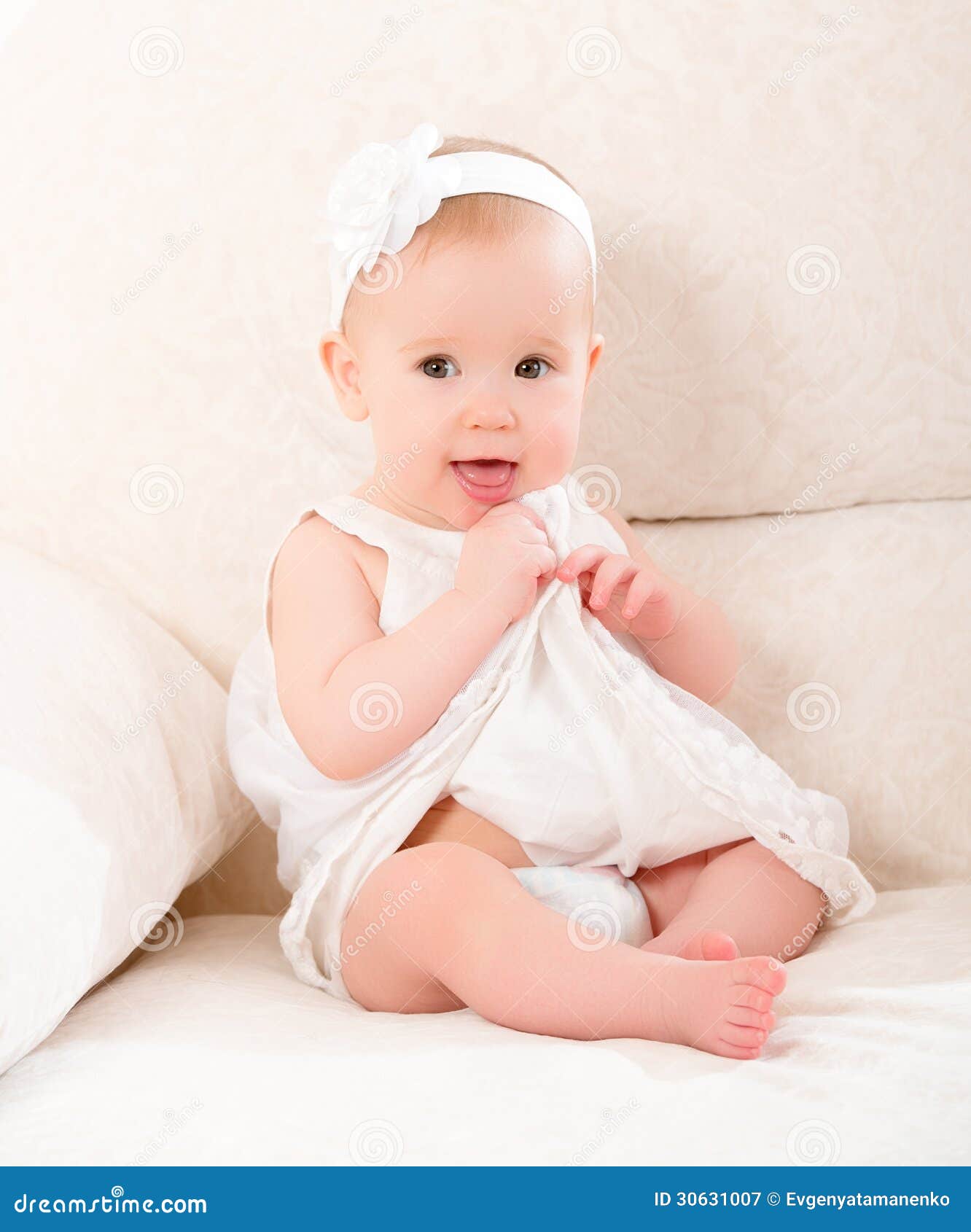 Little Cute Girl In A White Dress And With Flower Smiling Royalty Free