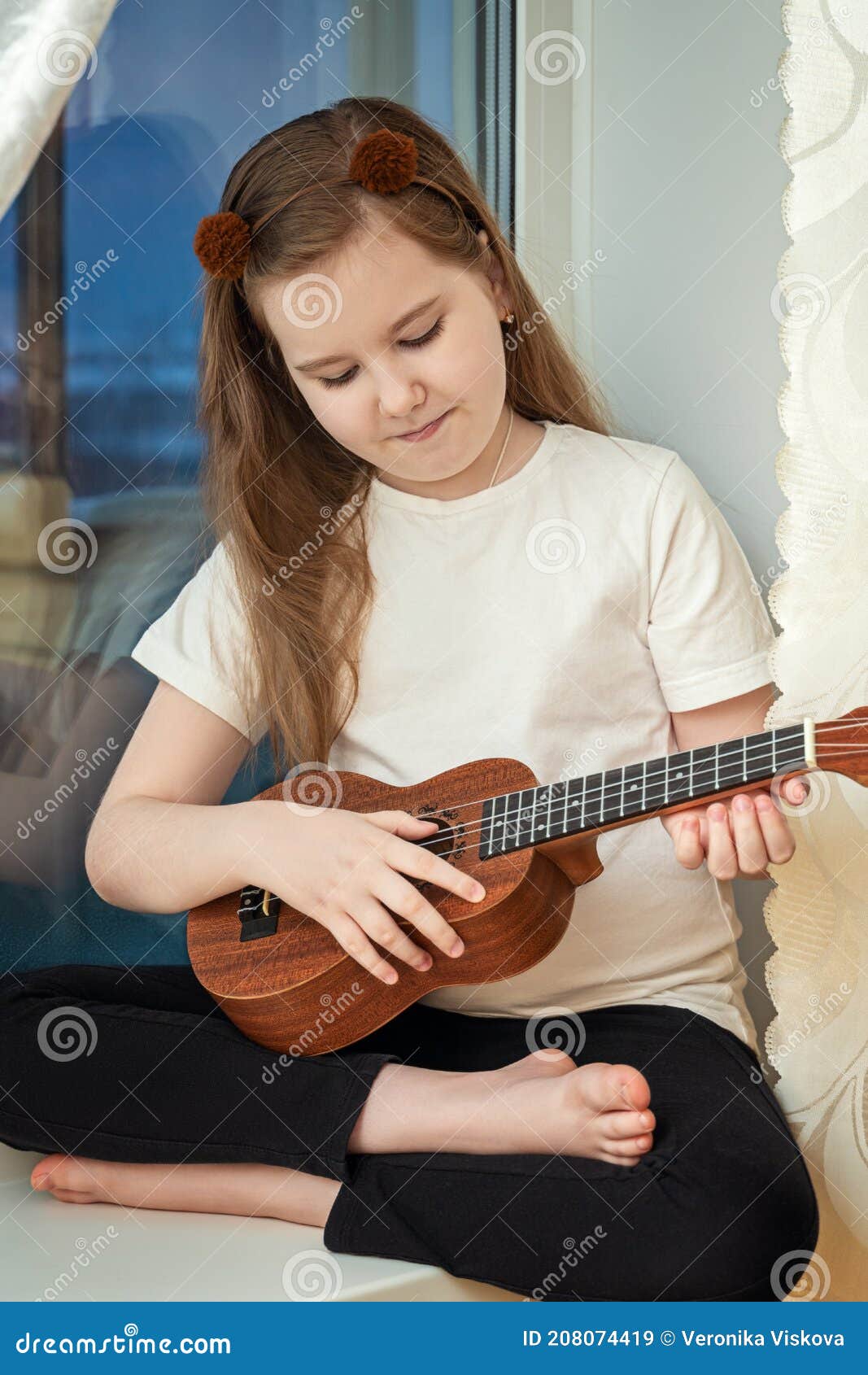 Little Cute Girl in White T-shirt and Black Leggings Sitting Inside of Home  and Playing Ukulele Stock Image - Image of cute, attractive: 208074419