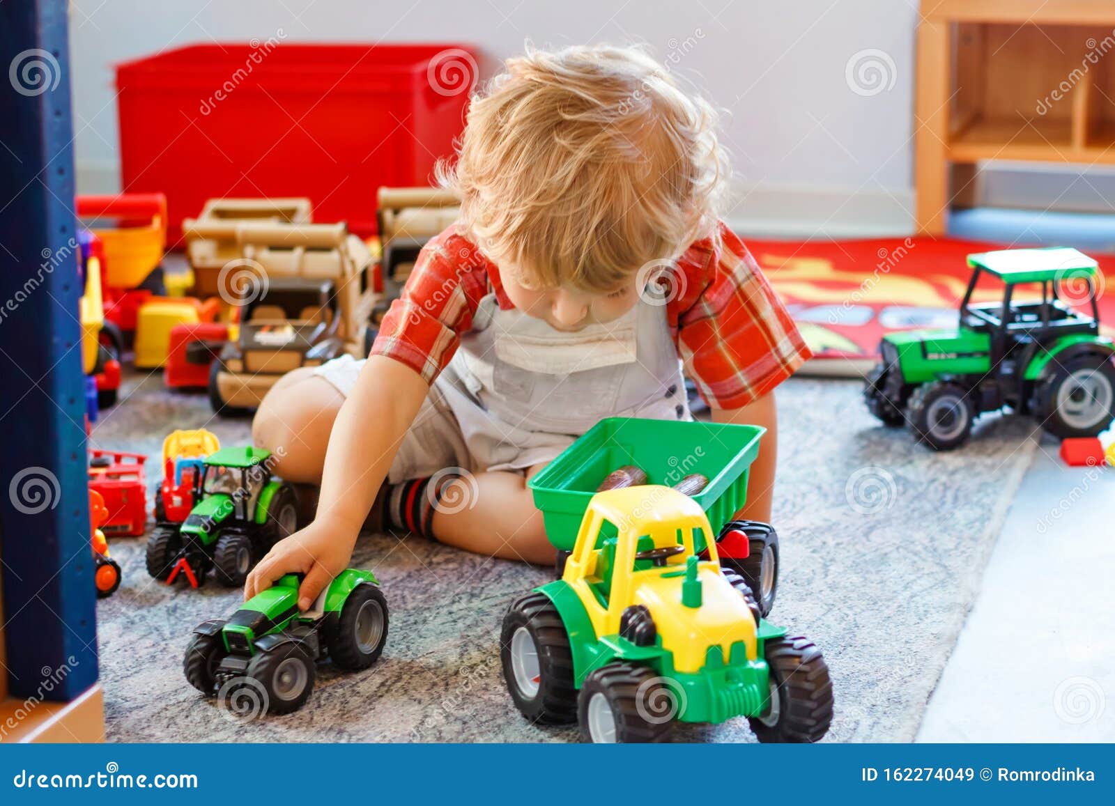 Little Boy Playing with Color Toys on Floor Stock Photo - Image of  bulldozer, little: 19039326