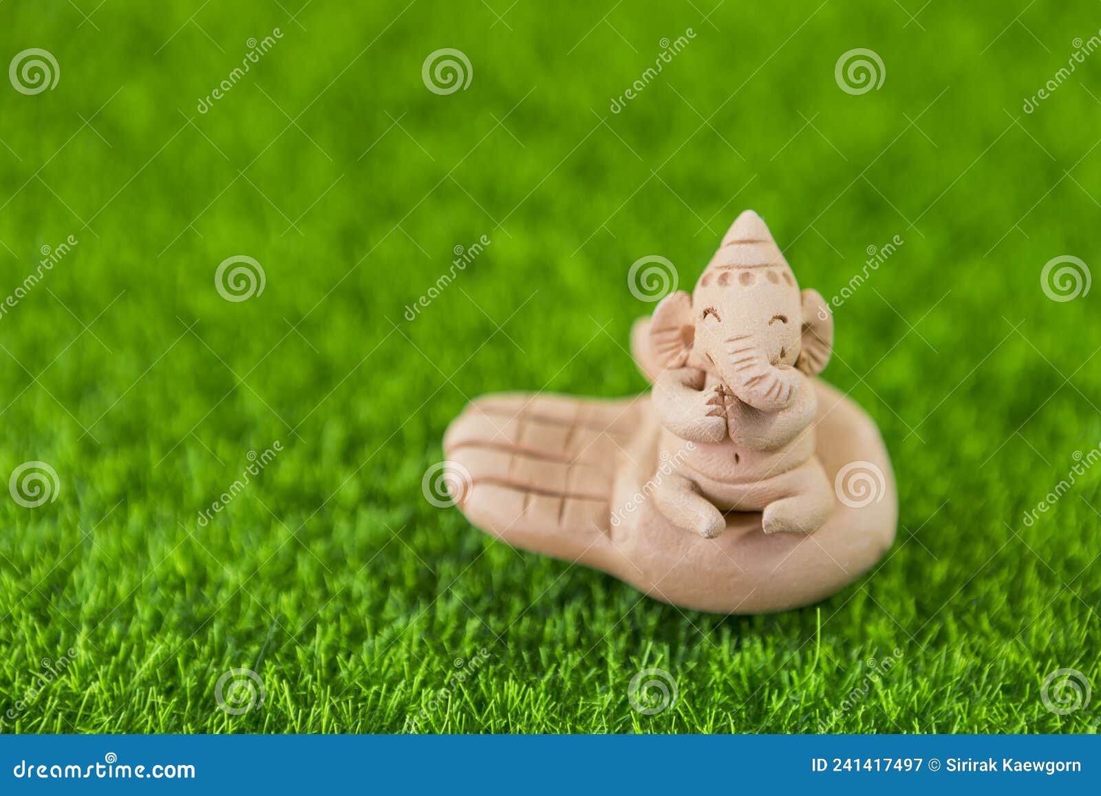 Little Ganesha on Hand on Green Grass Background, Elephant Clay ...