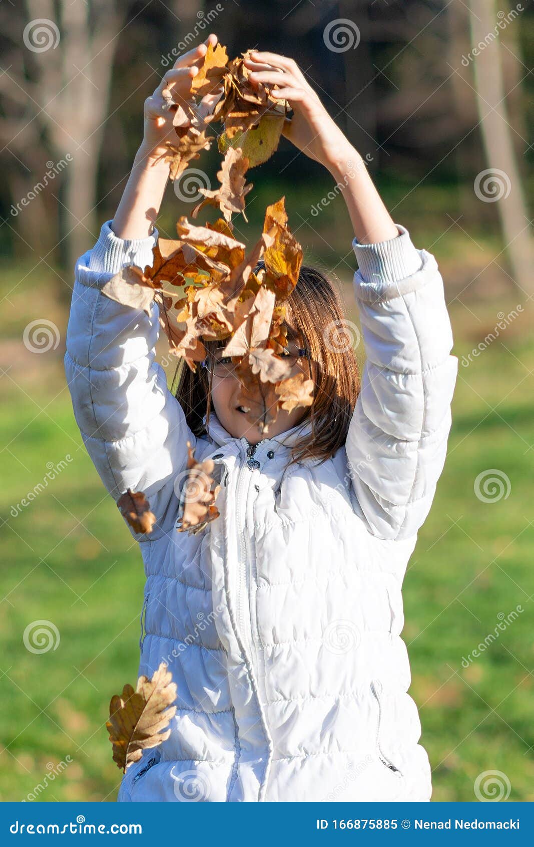 Little Girl in Autumn Park. Girl Playing with Leaves Stock Image ...