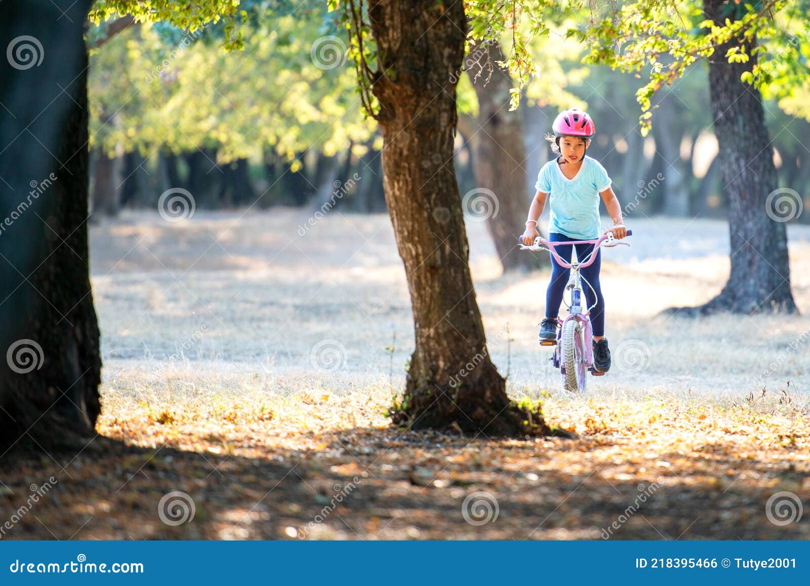 little girl with biking at sunset