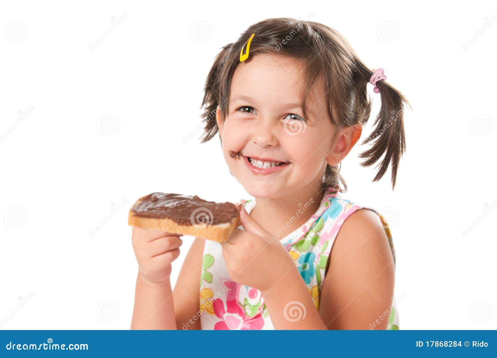 Little girl biting a snack stock photo. Image of holding 17868284