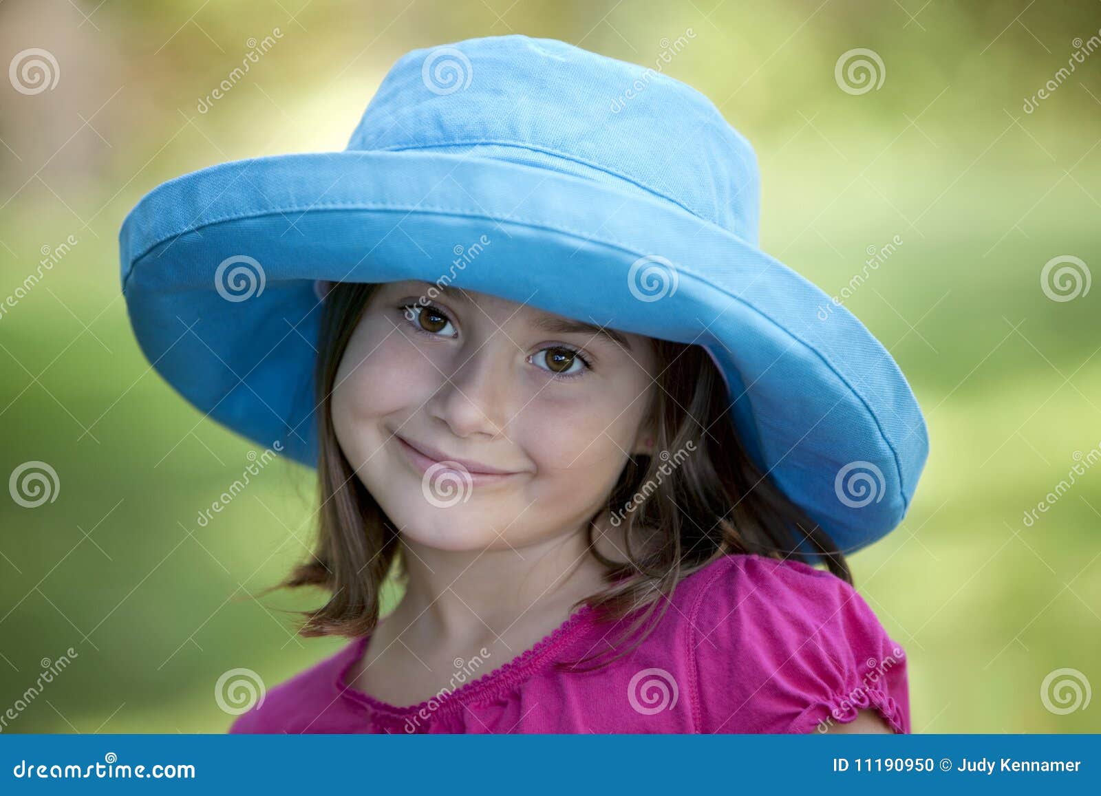 Little Girl in Blue Hat Outdoors Stock Photo Image of green