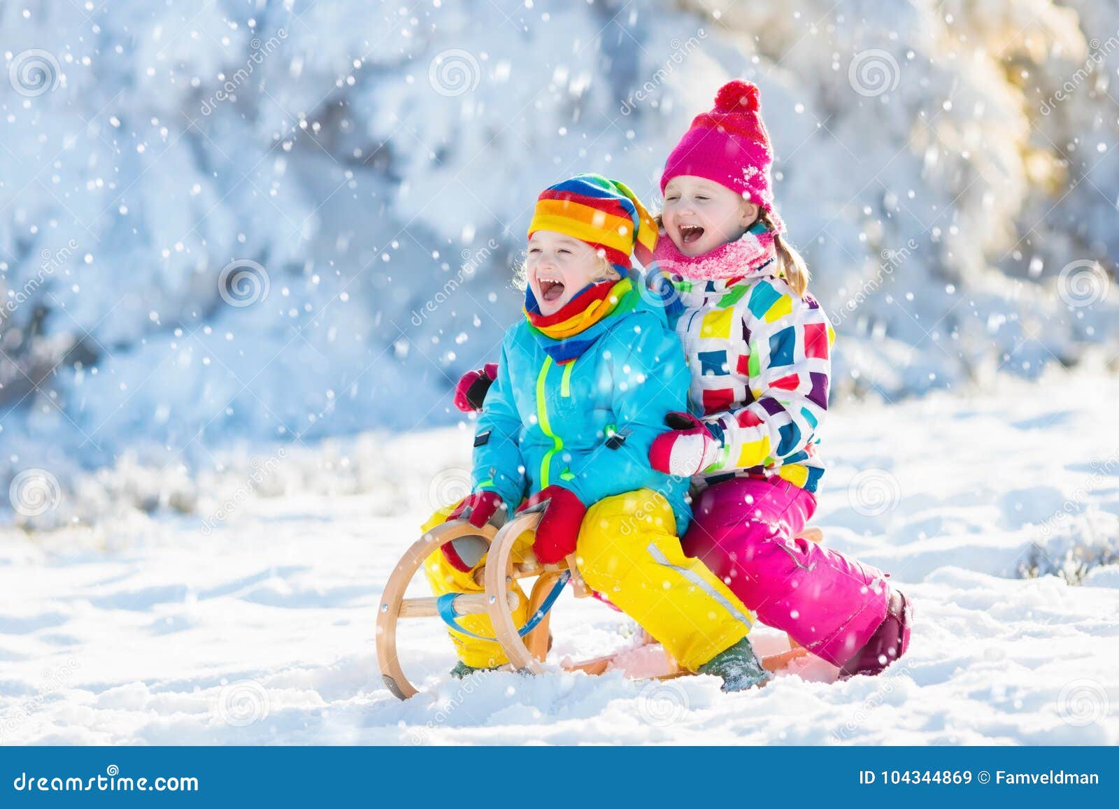 kids play in snow. winter sleigh ride for children