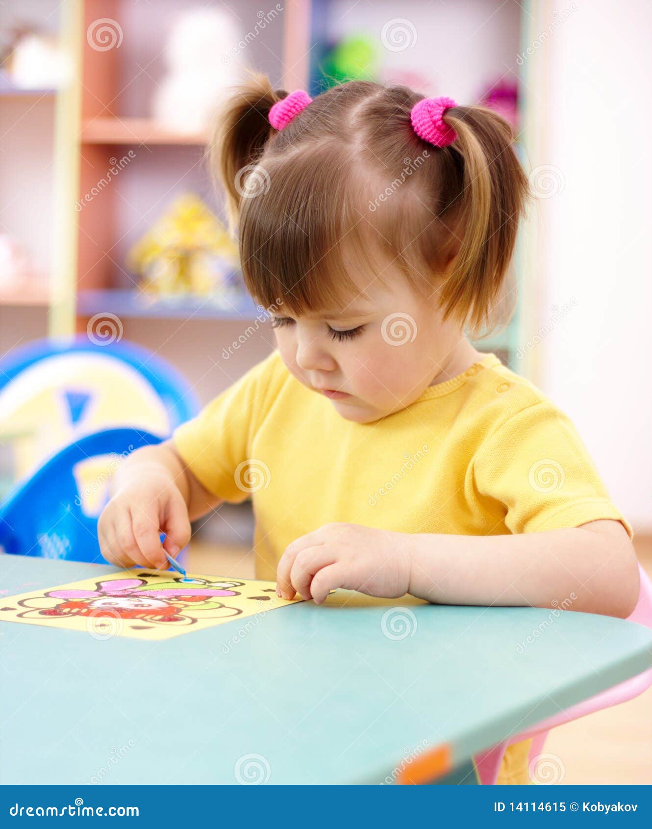 Little Girl Coloring A Picture In Preschool Royalty Free