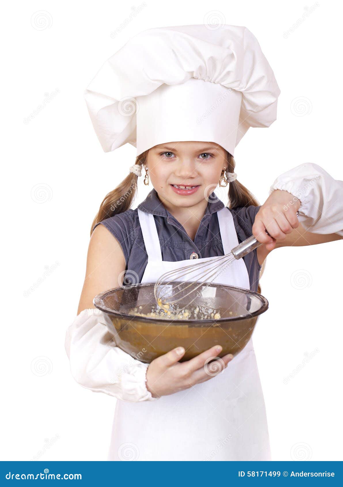 little girl cook whips whisk eggs in a large plate