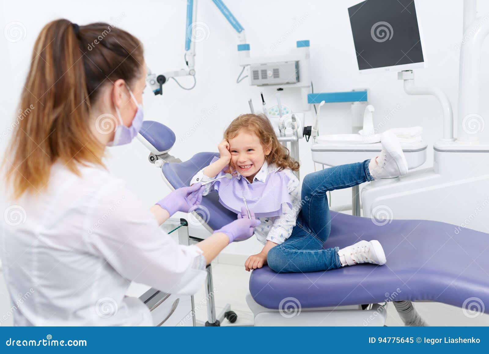 Premium Photo  The little girl is at the dentist. she sits in the