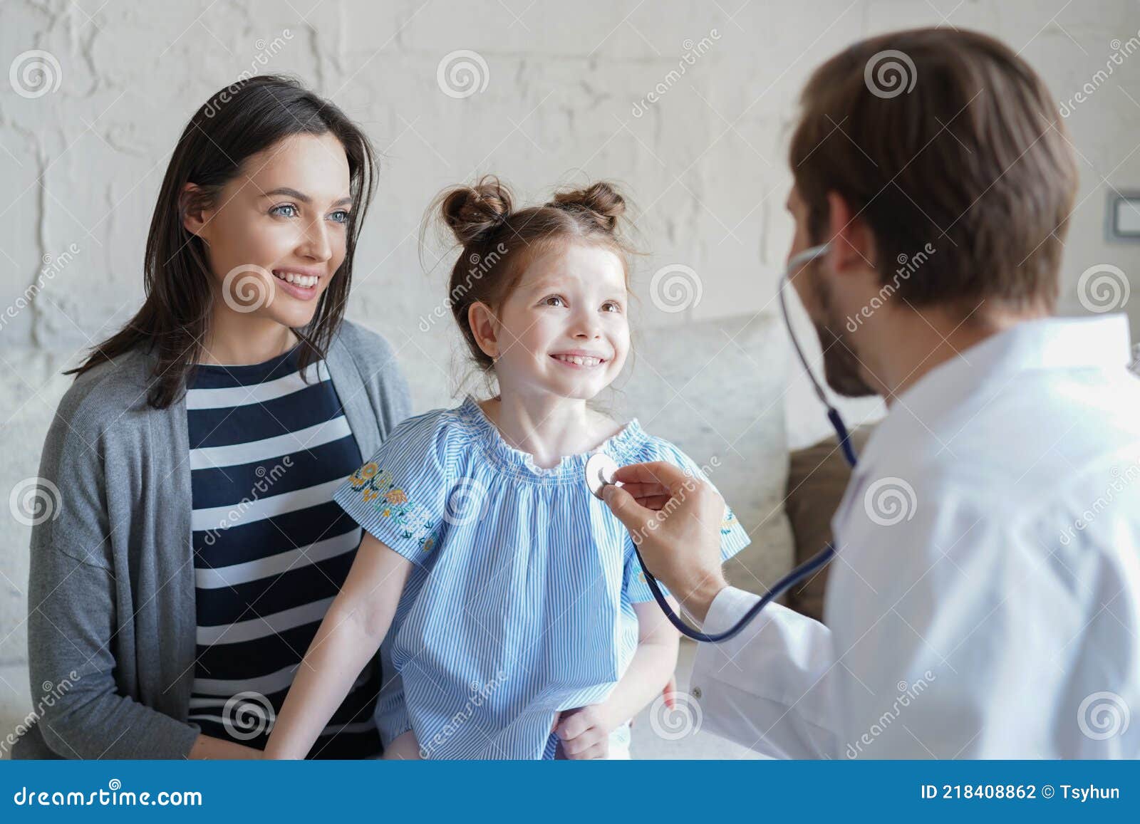 little girl at the doctor for a checkup. doctor auscultate the heartbeat of the child.