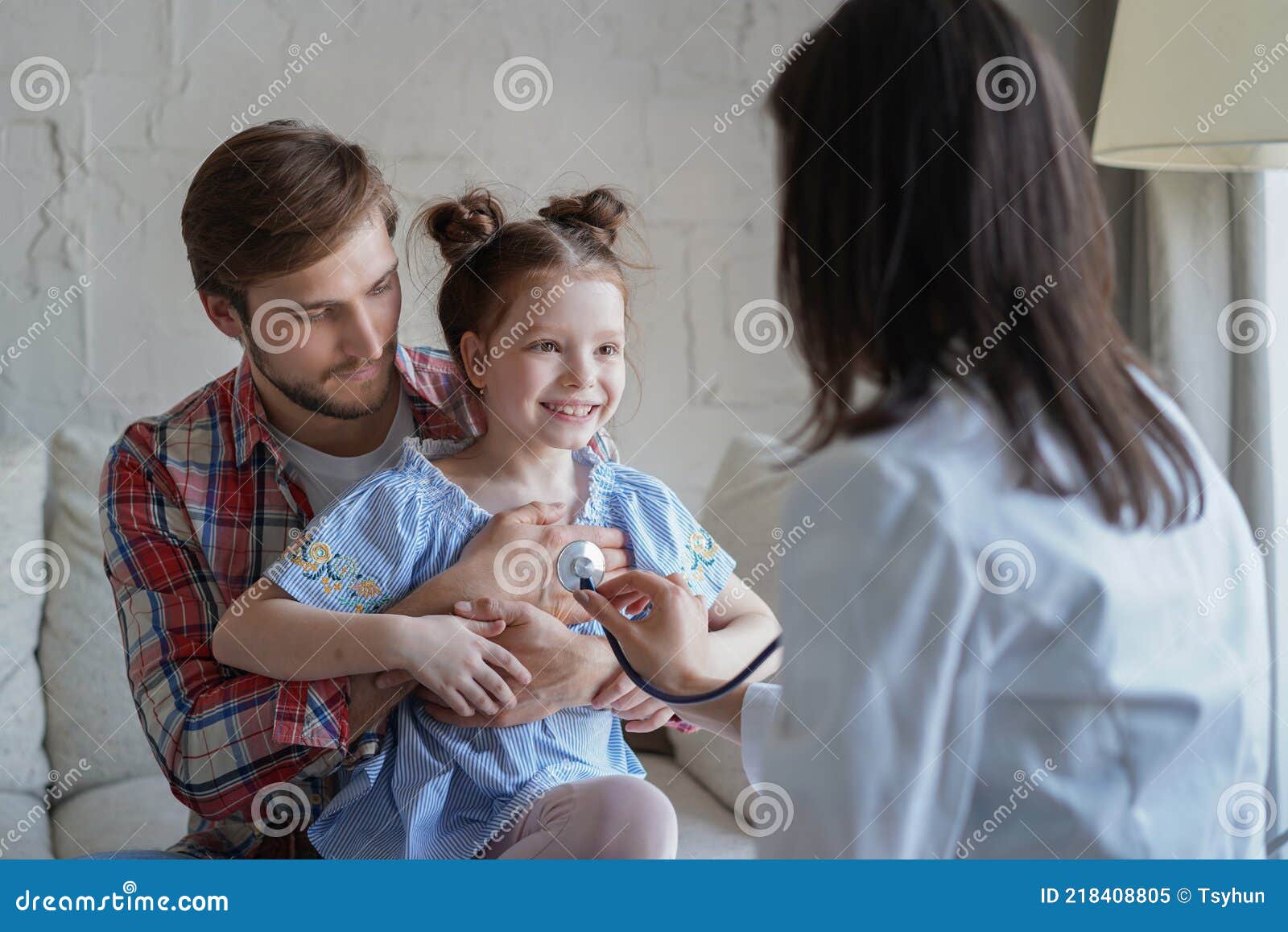 little girl at the doctor for a checkup. doctor woman auscultate the heartbeat of the child.