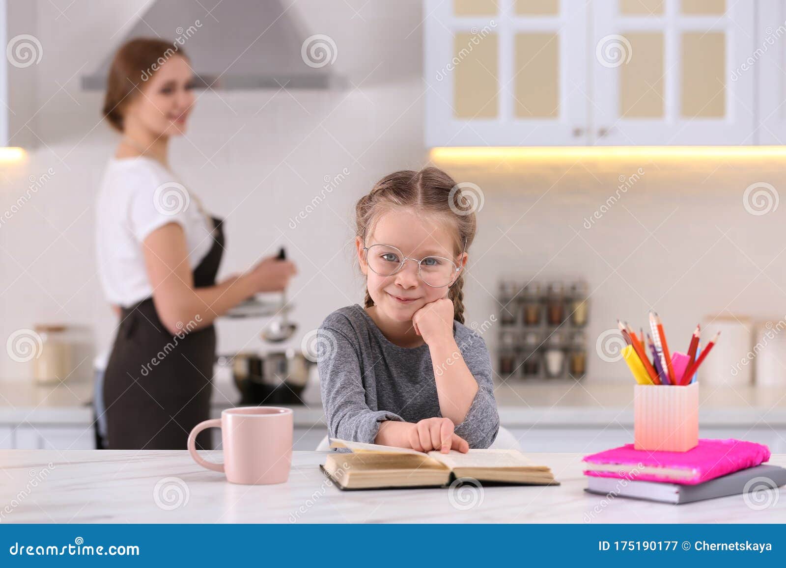 Girl Doing Homework While Mother Cooking In Kitchen Stock Image Image Of Daughter Kitchen 