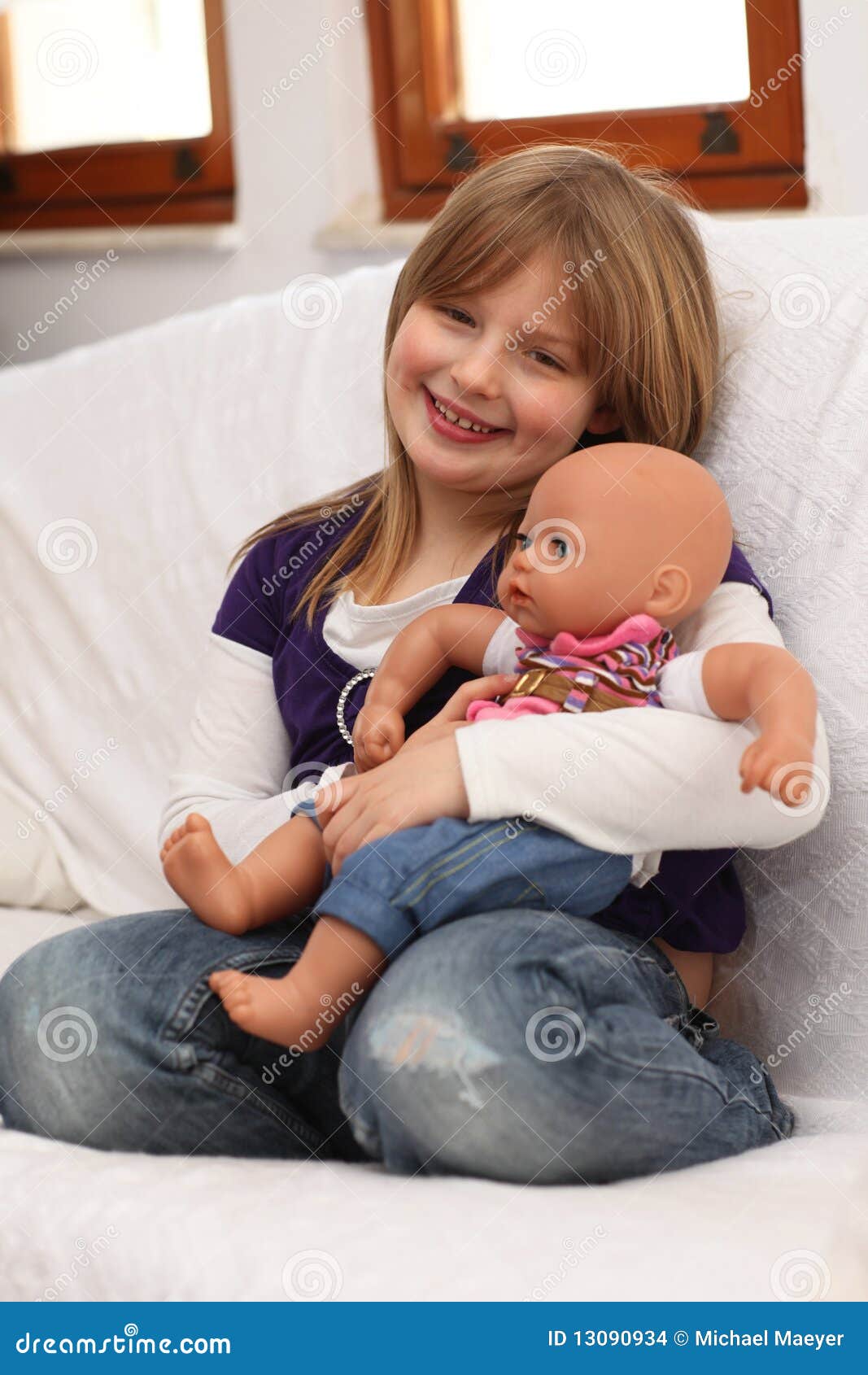 Little Girl with Doll on Sofa Stock Photo Image of dreams, comfort