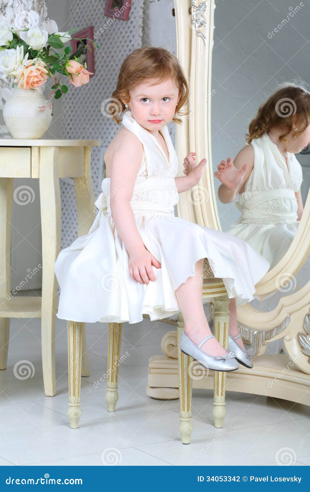 Little Girl In Dress Sitting In Front Of Mirror Stock 