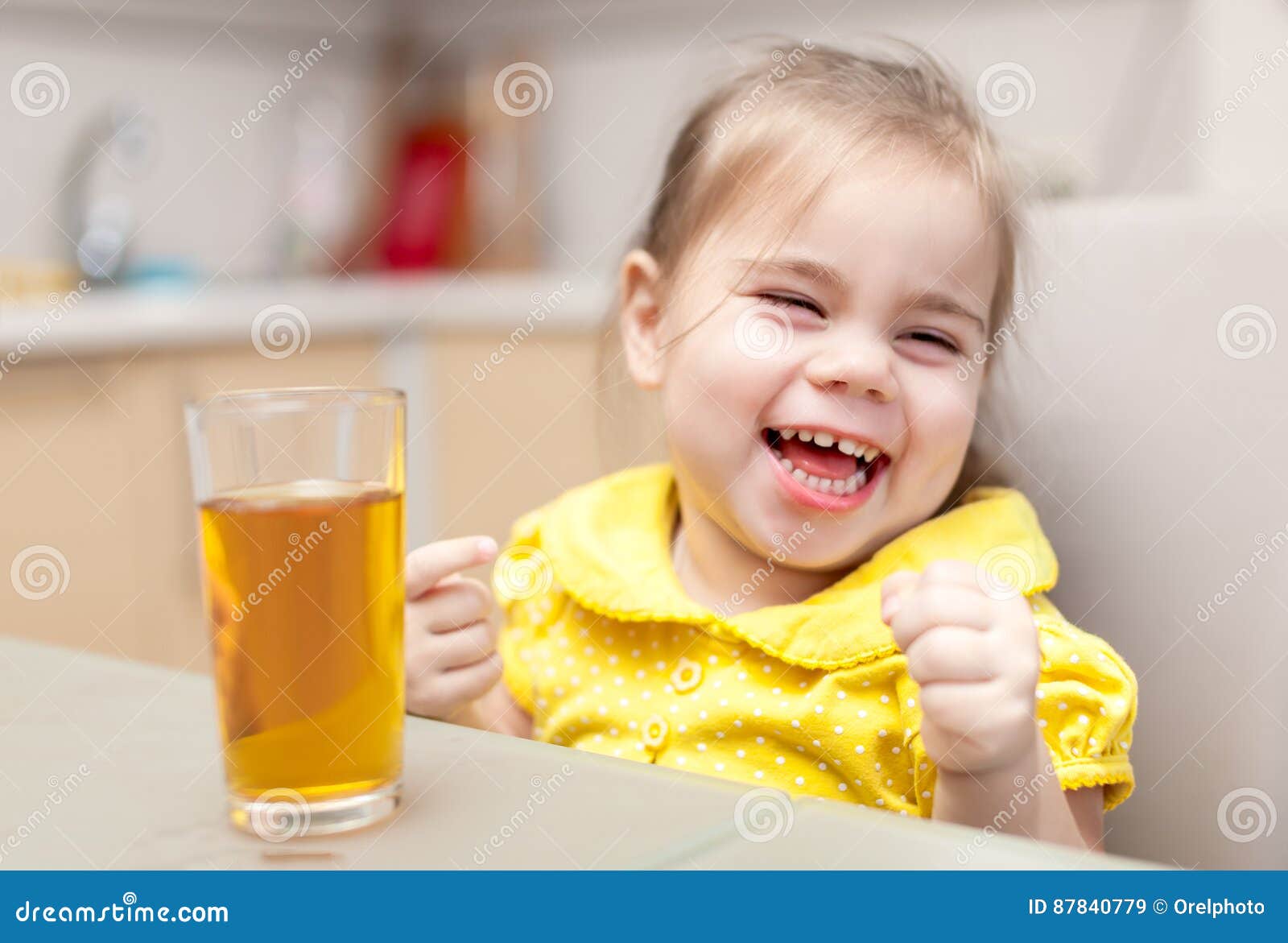 Little Girl Drinking Apple Juice Stock Image Image of happy, kitchen