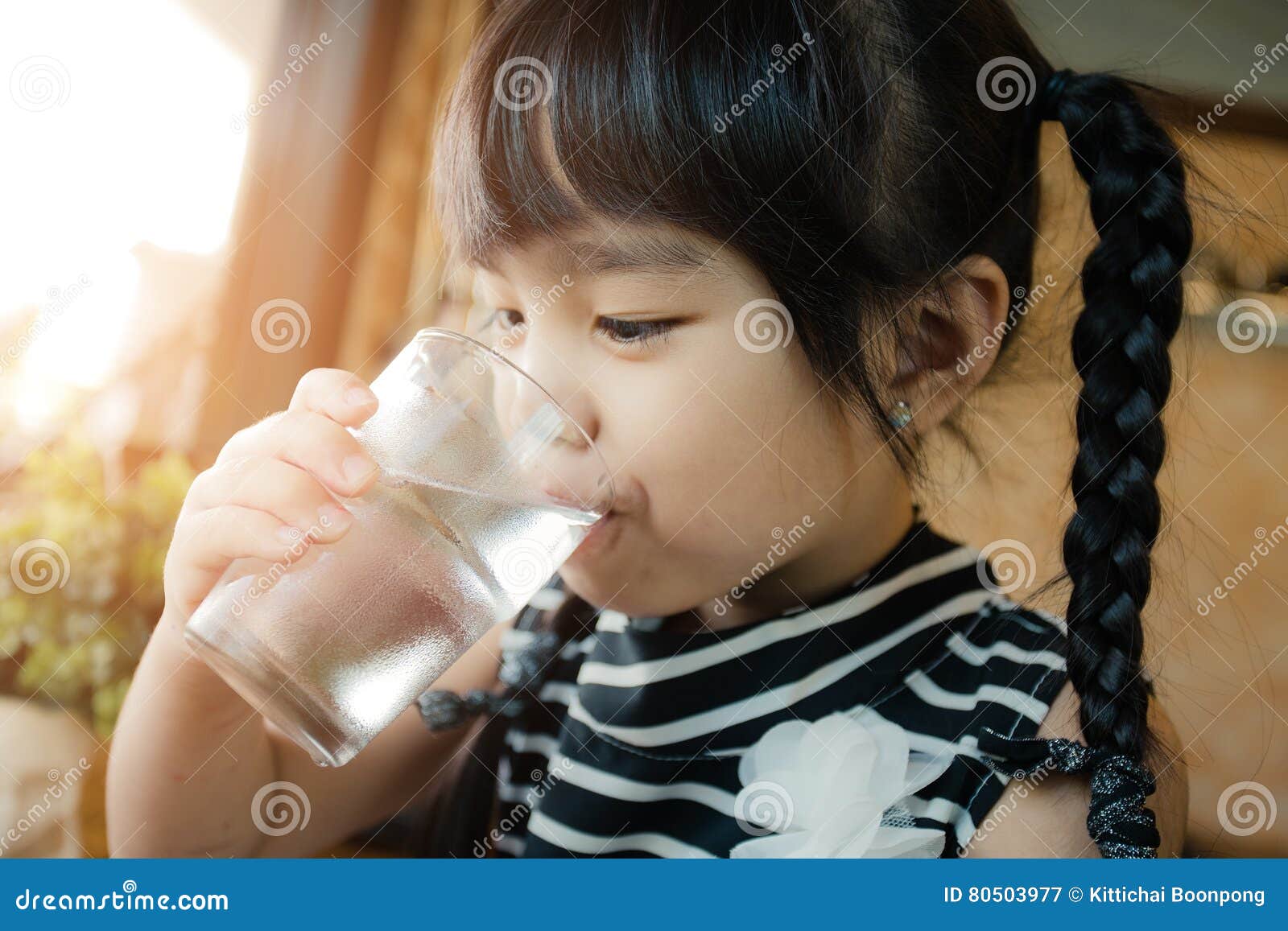 little girl drinking water.