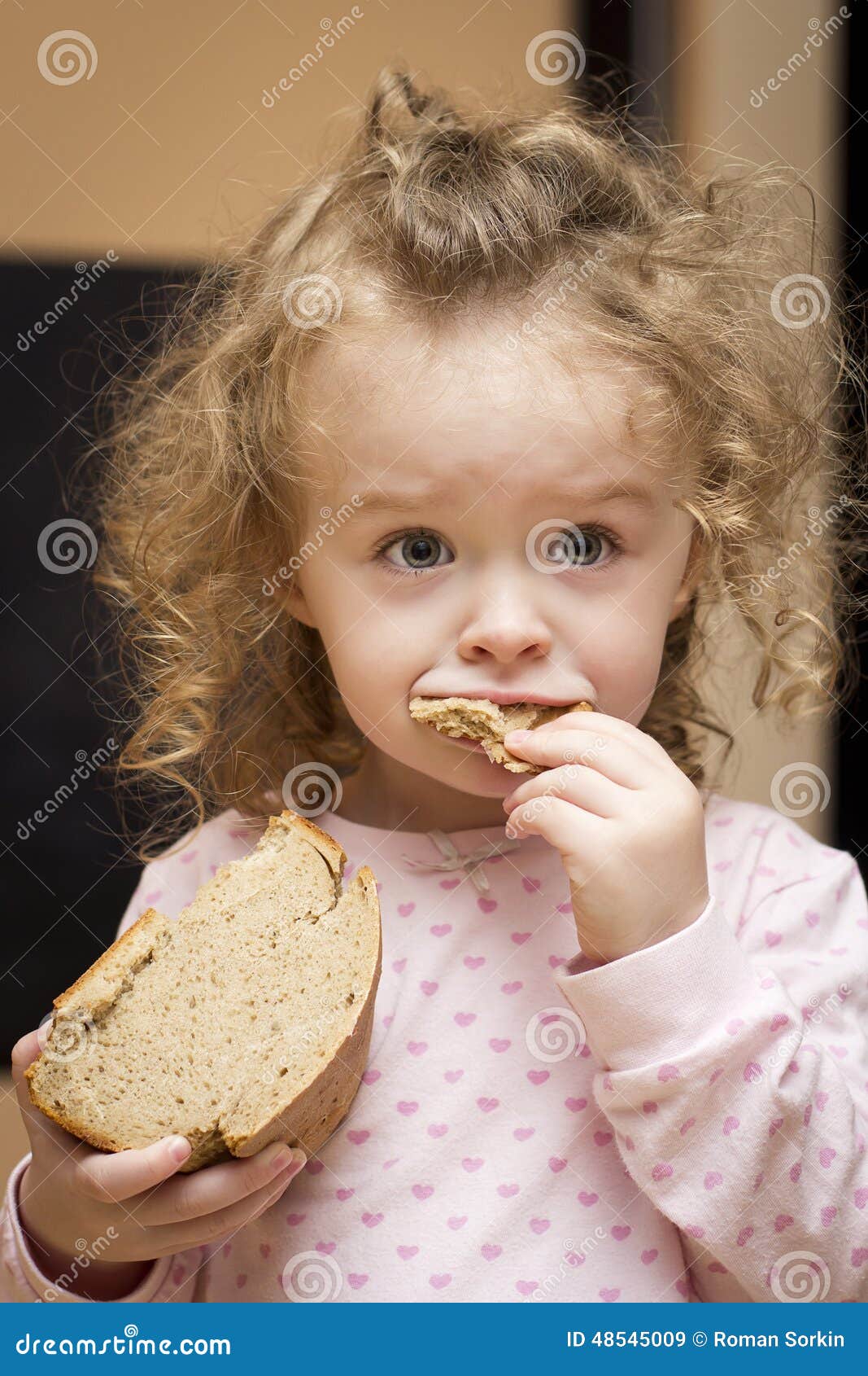 Little girl eating bread stock image. Image of bite, bread 48545009