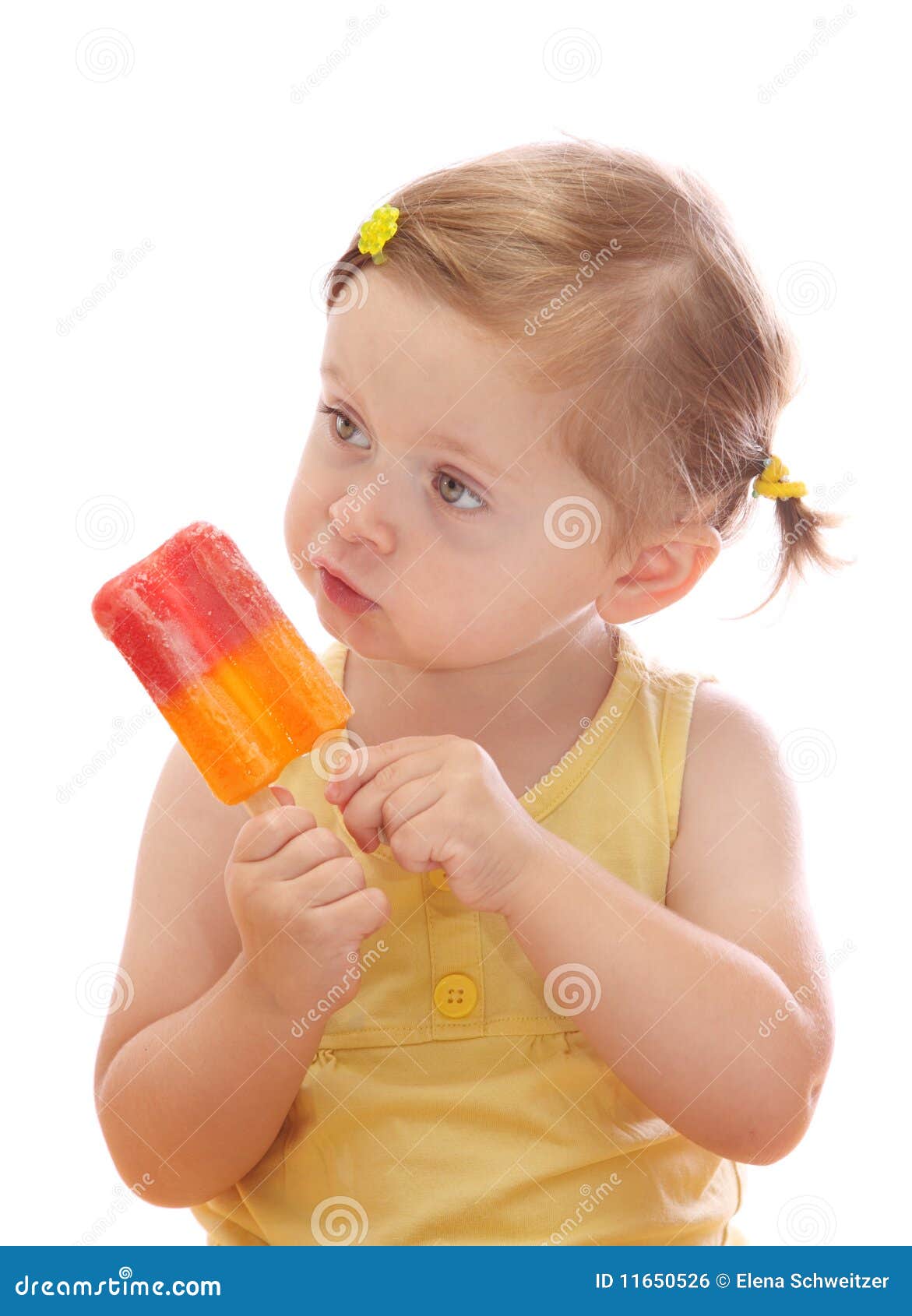 little girl eating colorful ice lolly