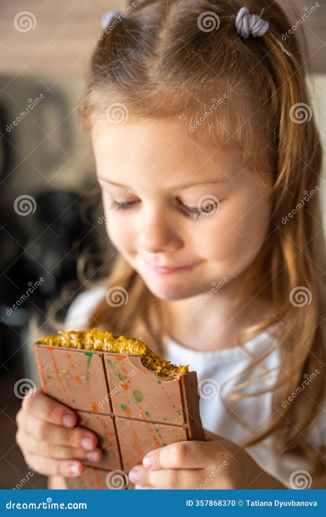 little girl eating dubai chocolate with pistachio paste and kataifi dough. confectionery handmade sweets at home in the
