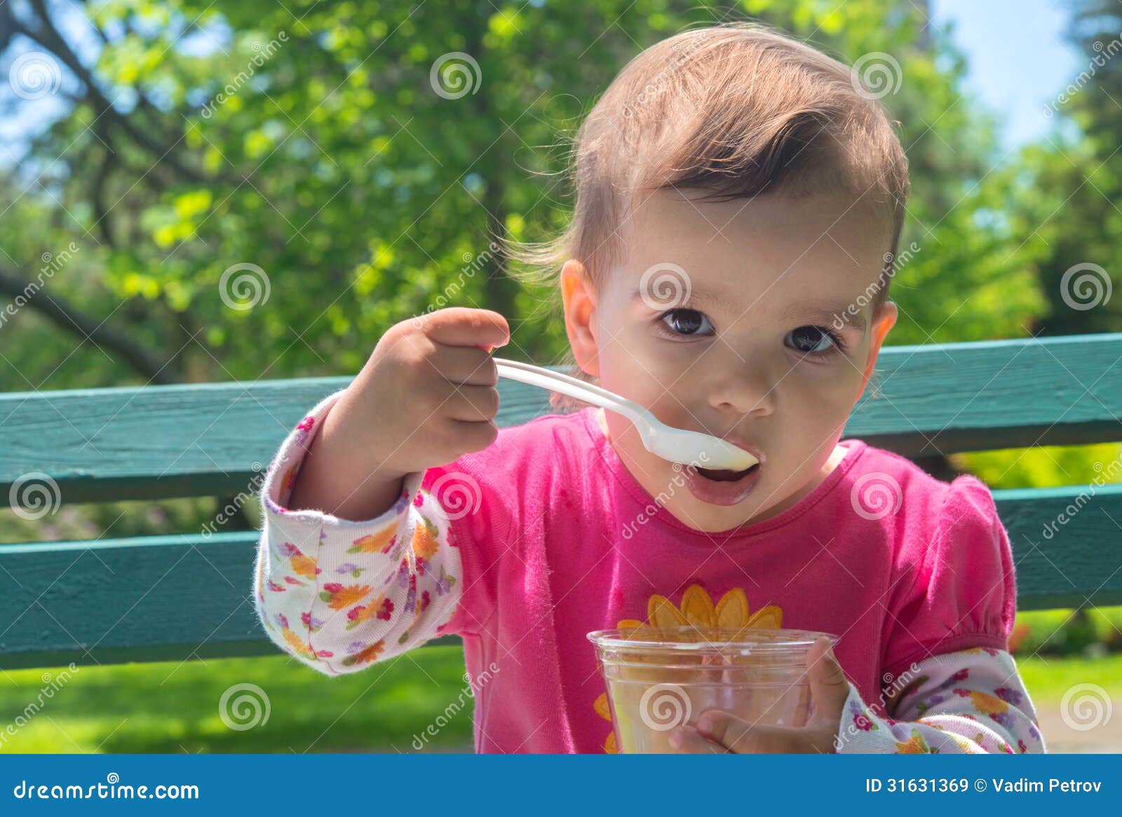 little girl eating ice cream outdoor