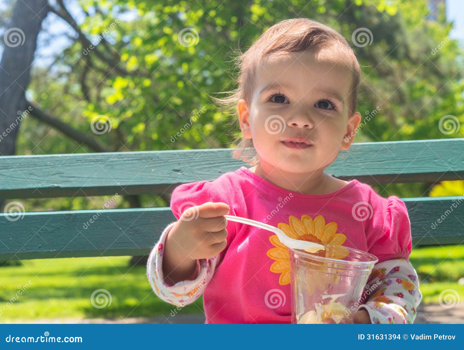 little girl eating ice cream outdoor