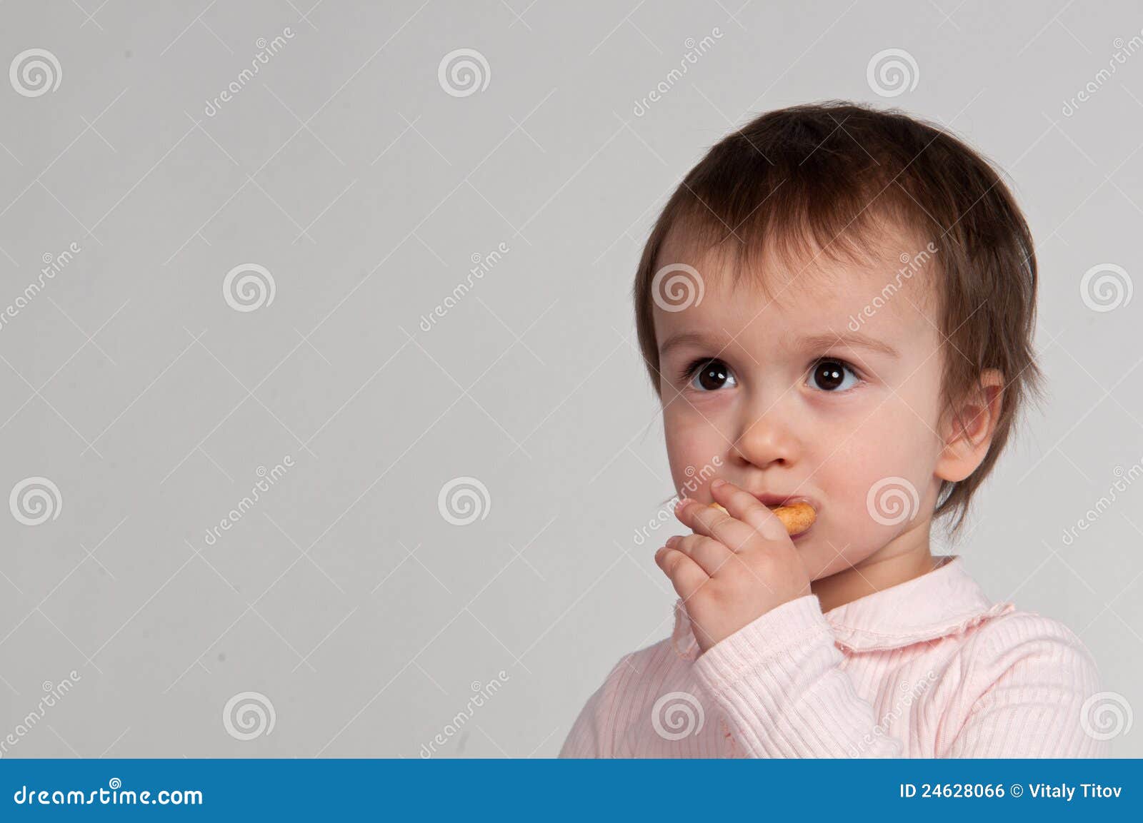 Little girl eating snacks stock photo. Image of isolated 24628066