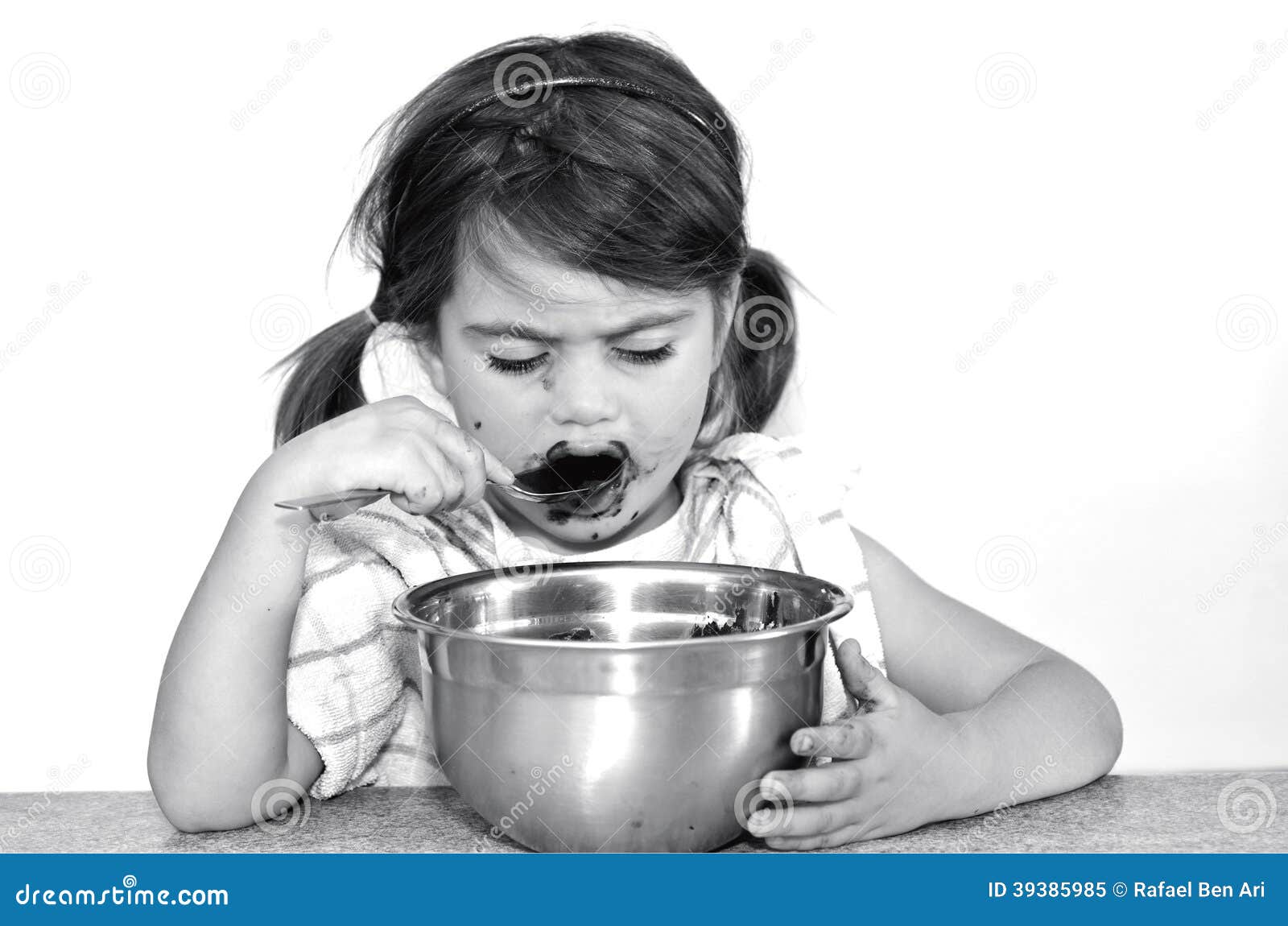 little girl eats chocolate cream