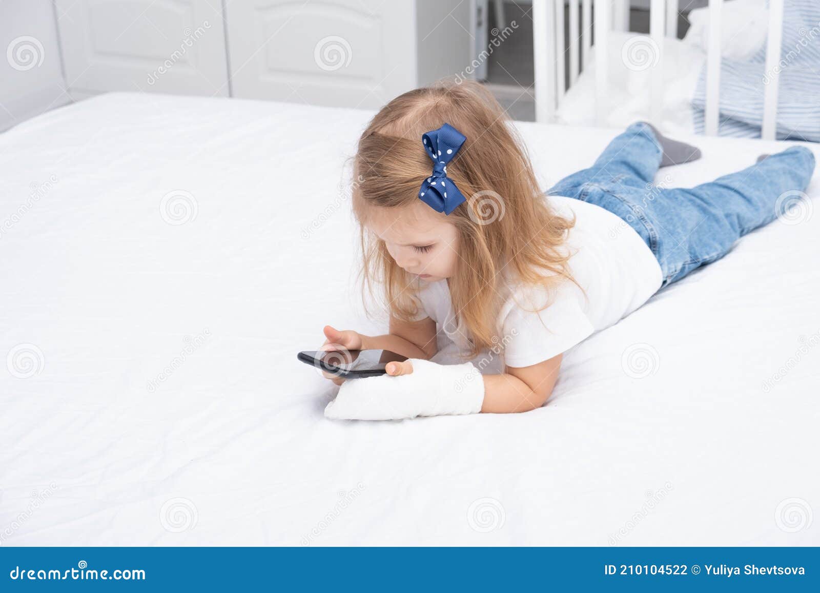Little Girl with Hand in Cast Laying in Bed Using Smartphone, Watching  Cartoon or Education Video Stock Photo - Image of learning, accident:  210104522